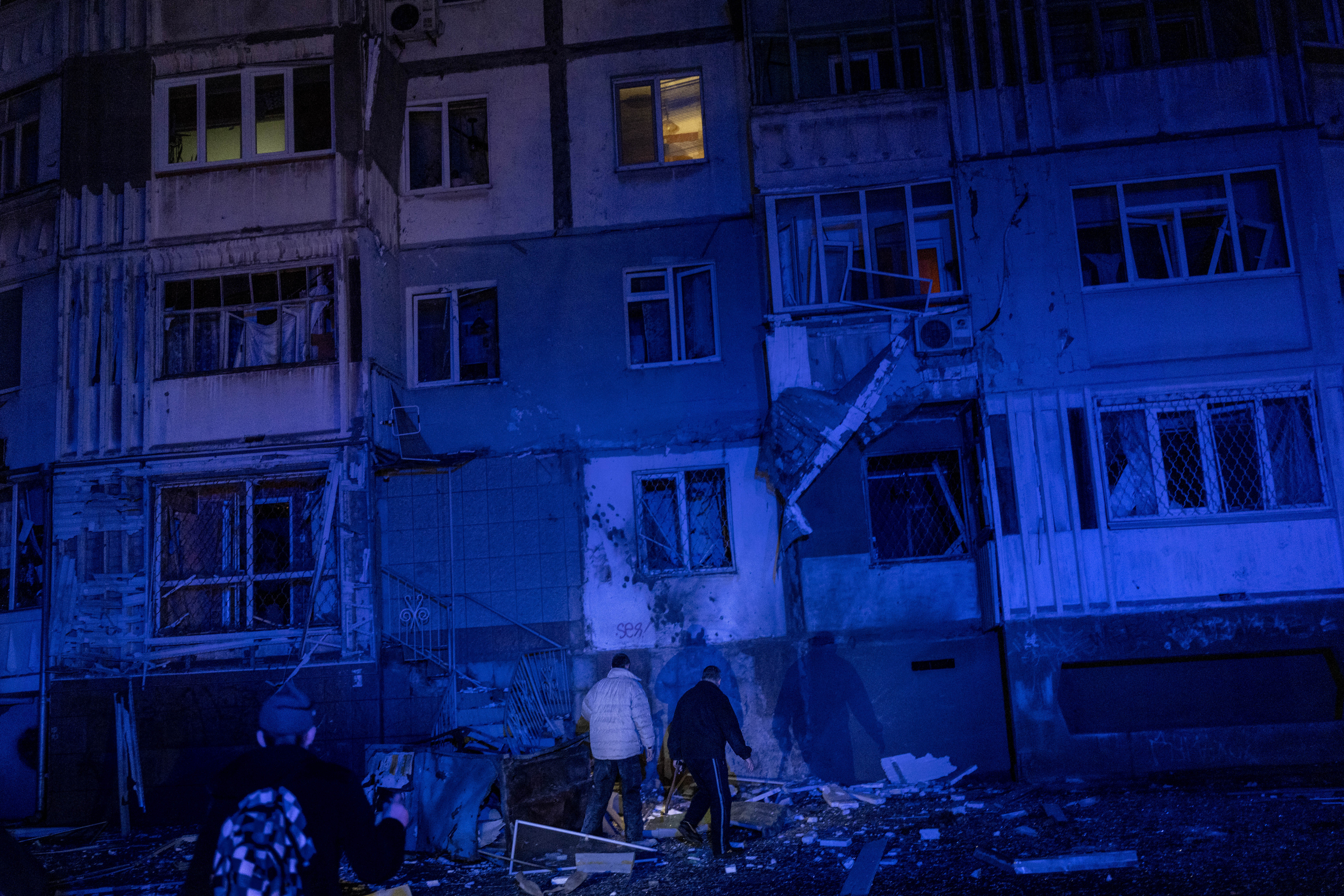 Resident walk amid debris after a Russian attack in Kherson, southern Ukraine