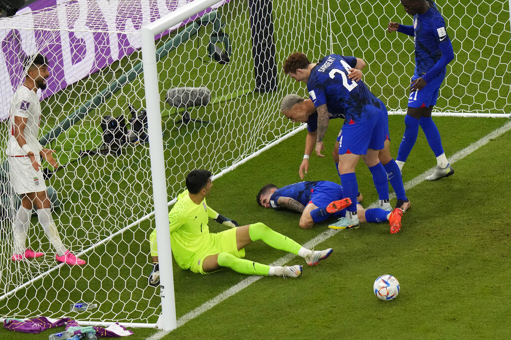 Christian Pulisic of the US lays injured on the pitch after he scored his side’s opening goal during the World Cup Group B match between Iran and the US at the Al Thumama Stadium in Doha, Qatar, November 29, 2022