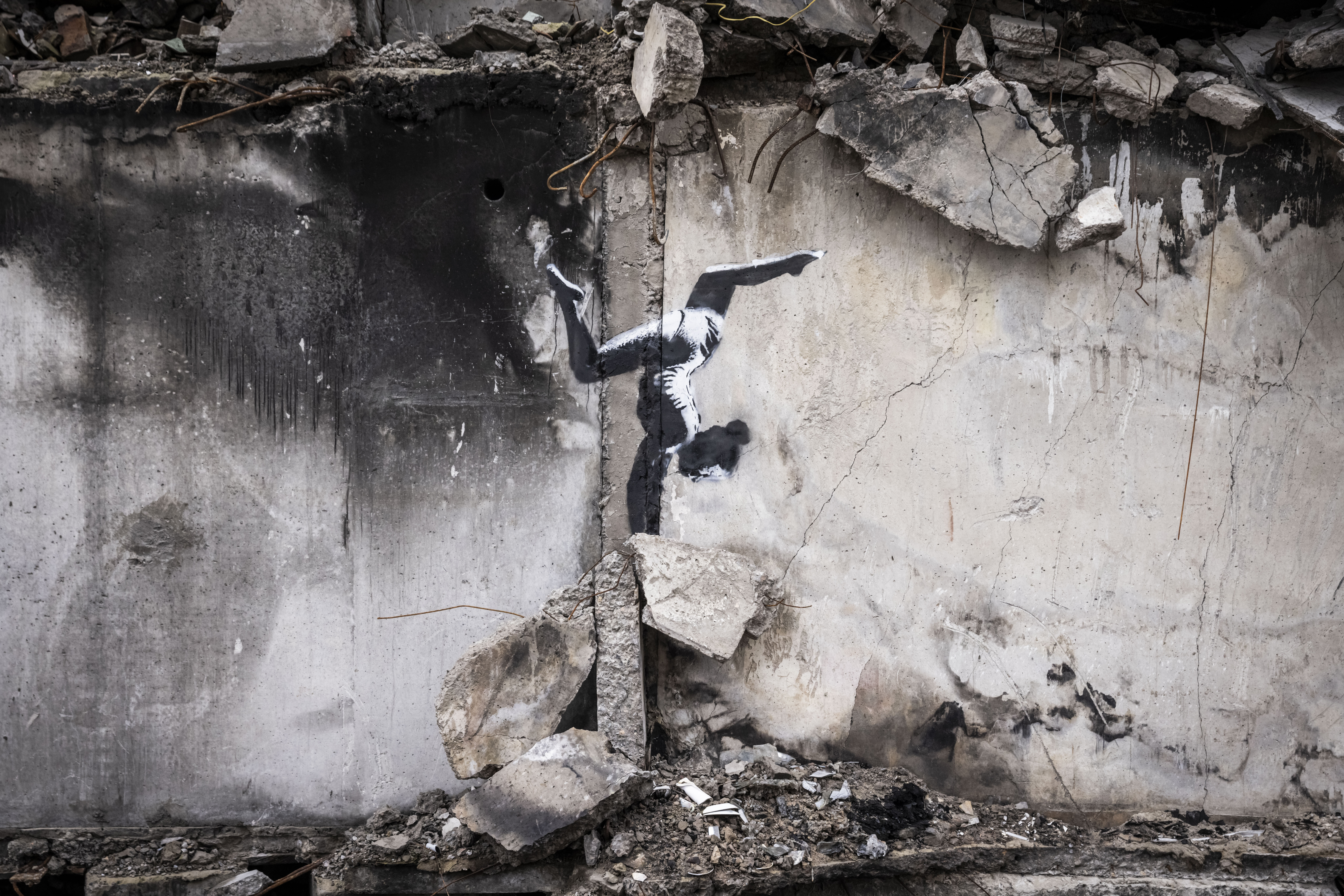 Graffiti of a woman in a leotard doing a handstand is seen on the wall of a destroyed building in Borodyanka on November 11, 2022 in Kyiv Region, Ukraine.