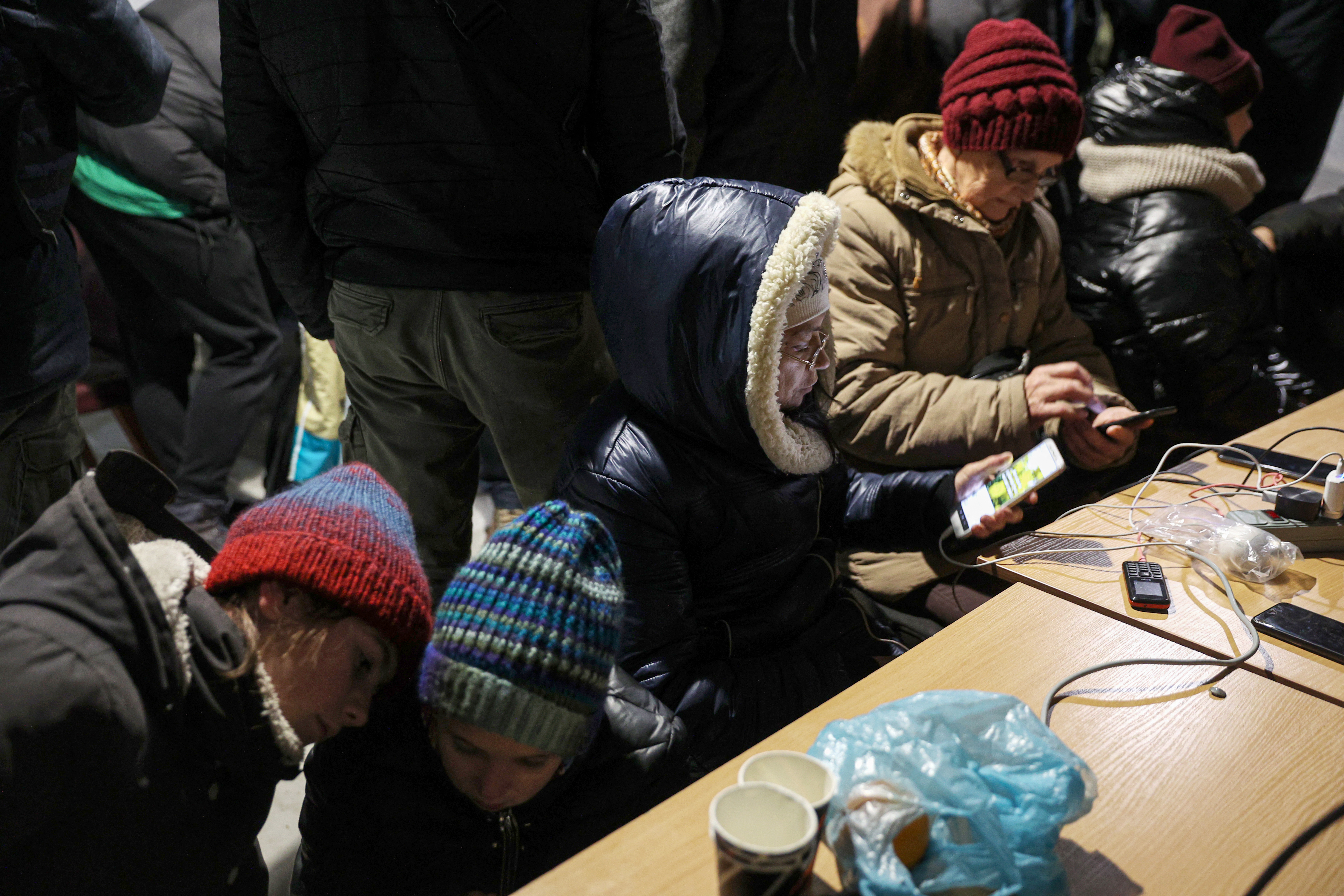 Residents charge their devices, use the internet and get warm at a ‘Point of Invincibility’ in Kherson, Ukraine. The mobile centres are designed to help people struggling without heat or power