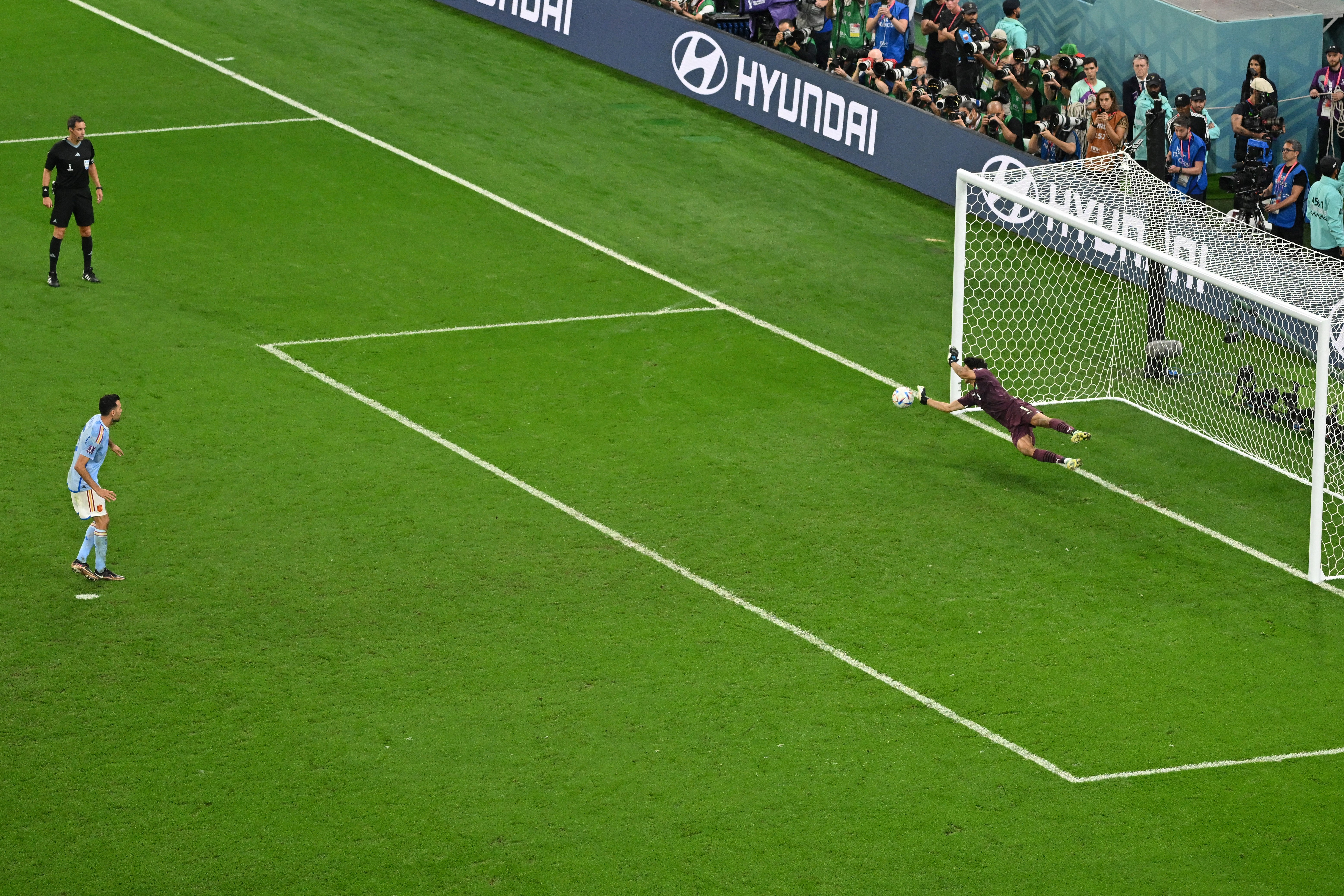 Yassine Bounou saves Sergio Busquets’s penalty kick in Morocco’s round of 16 match against Spain.