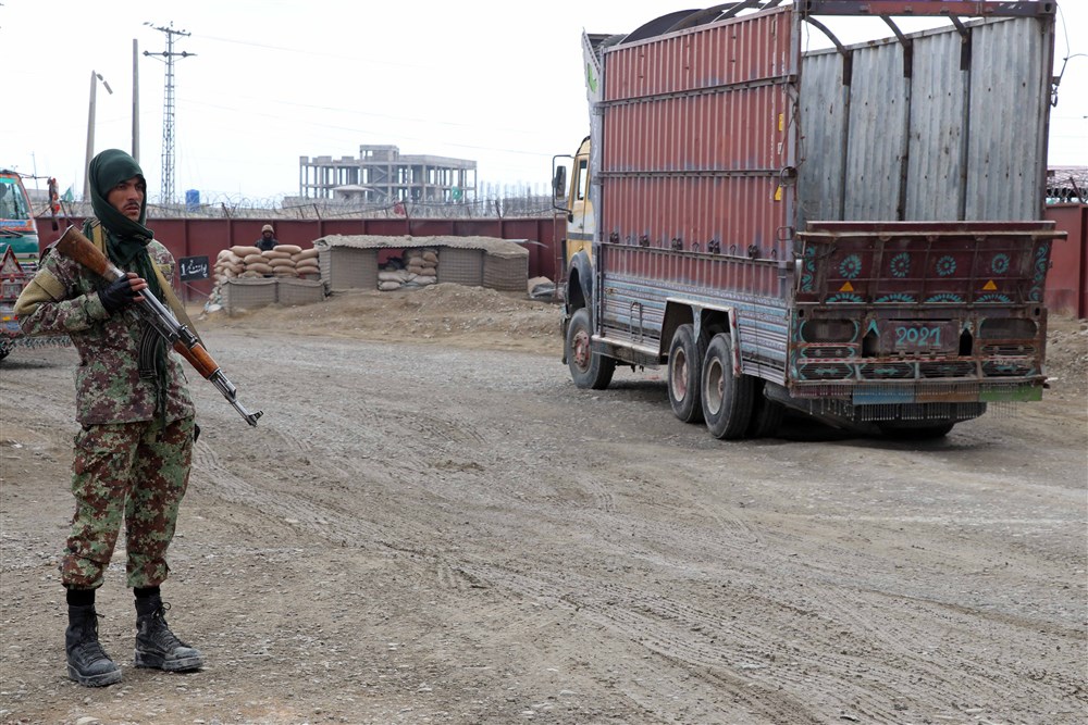 A Taliban fighter stands guard at the Spin Boldak border crossing in Afghanistan a day after shelling killed six Pakistani civilians in Chaman, a Pakistani city on the other side of the border. [EPA]
