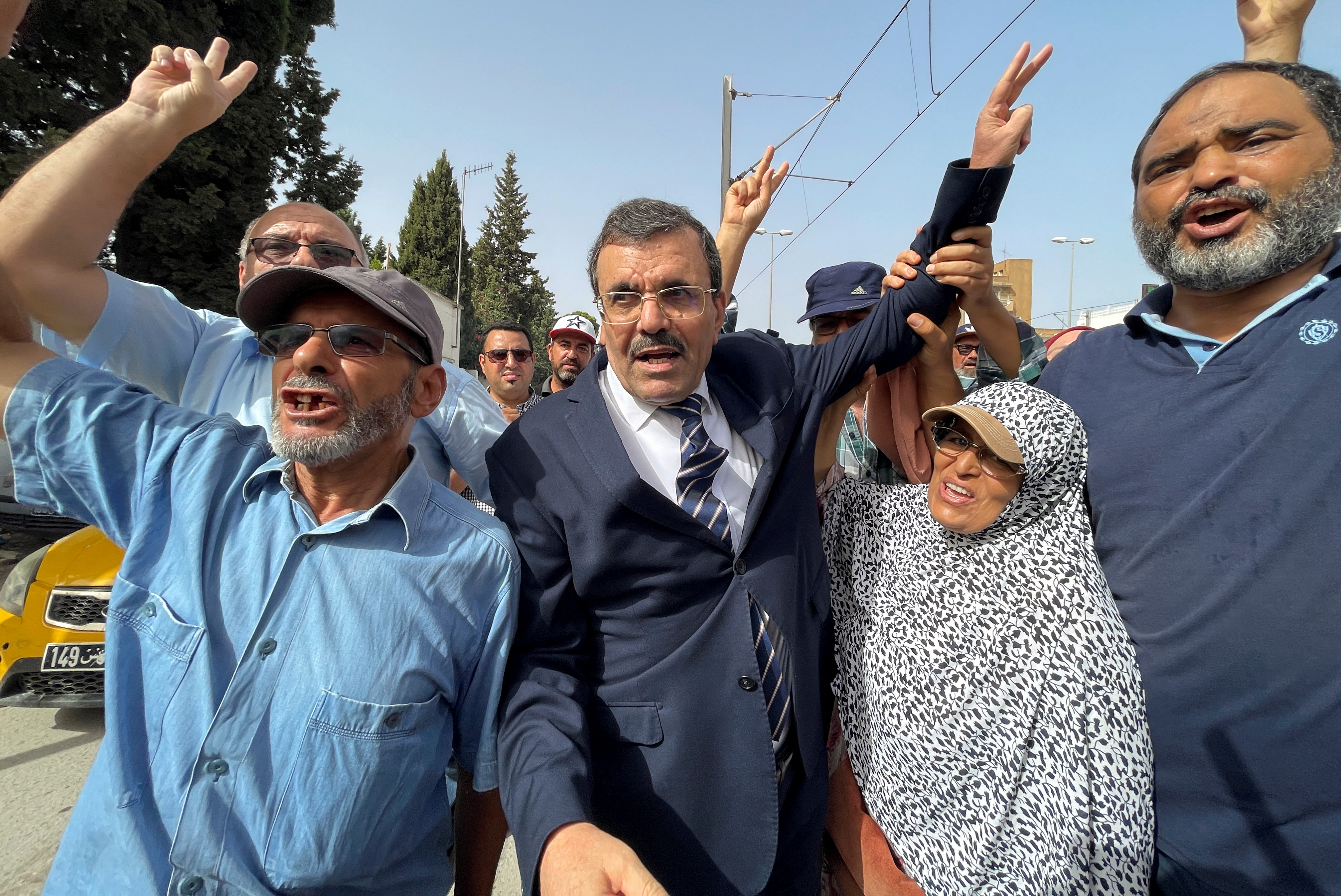 Ali Larayedh, senior official of Tunisia's Islamist opposition party Ennahda and former prime minister, gestures while surrounded by his supporters, upon his arrival for questioning by anti-terrorism police, in Tunis,Tunisia September 19, 2022. REUTERS/Jihed Abidellaoui