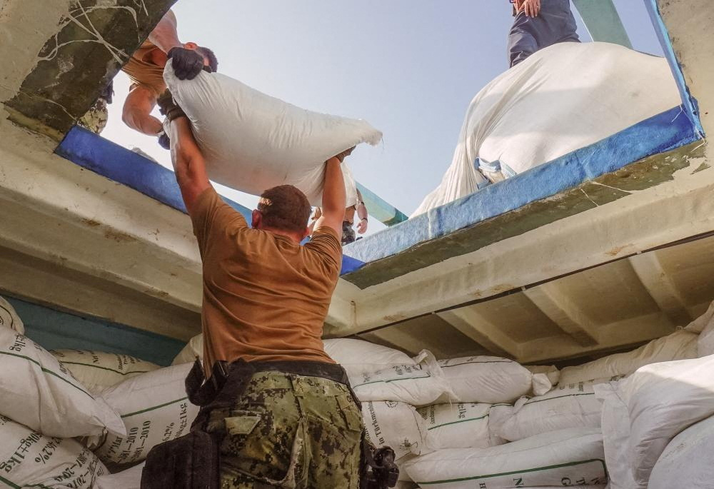 Sailors from the guided-missile destroyer USS The Sullivans (DDG 68) inventory a large quantity of urea fertiliser and ammonium perchlorate discovered on a fishing vessel intercepted by US naval forces while transiting international waters in the Gulf of Oman in Arabian Sea, in this photo taken on November 9, 2022 and provided by the US Navy.