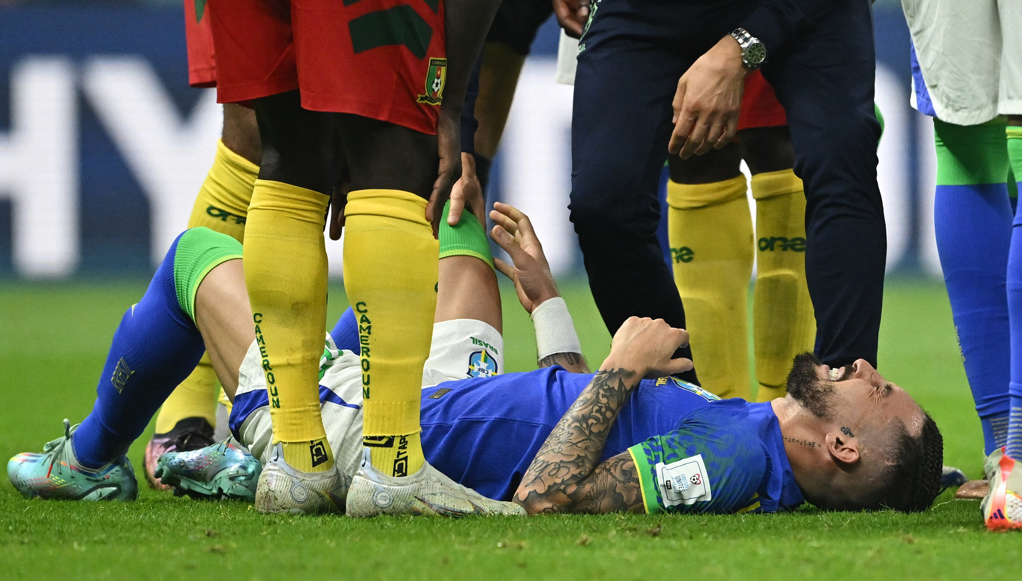 Soccer Football - FIFA World Cup Qatar 2022 - Group G - Cameroon v Brazil - Lusail Stadium, Lusail, Qatar - December 2, 2022 Brazil's Alex Telles receives medical attention