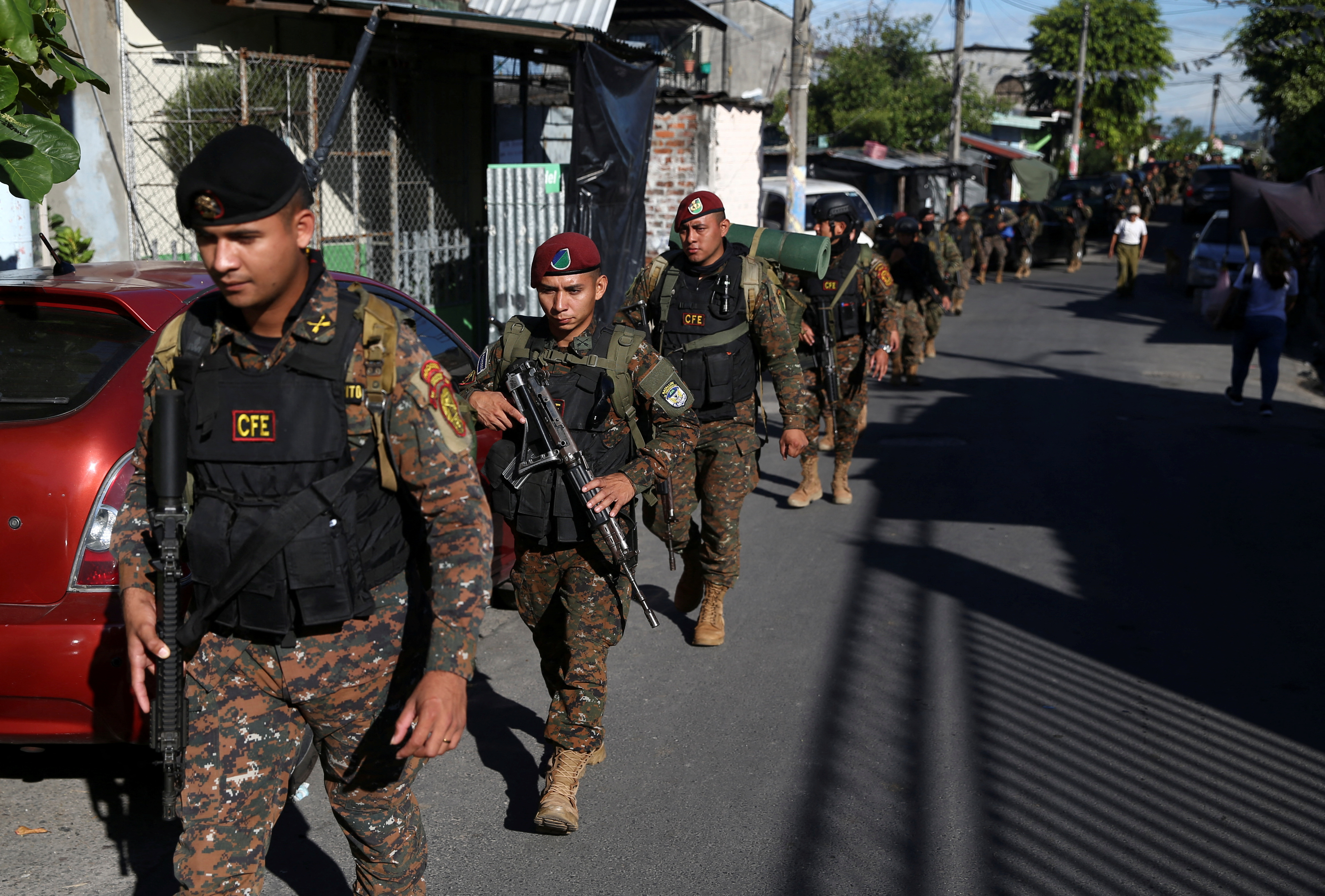 Troops march through the Salvadoran neighbourhood of Soyapango in December