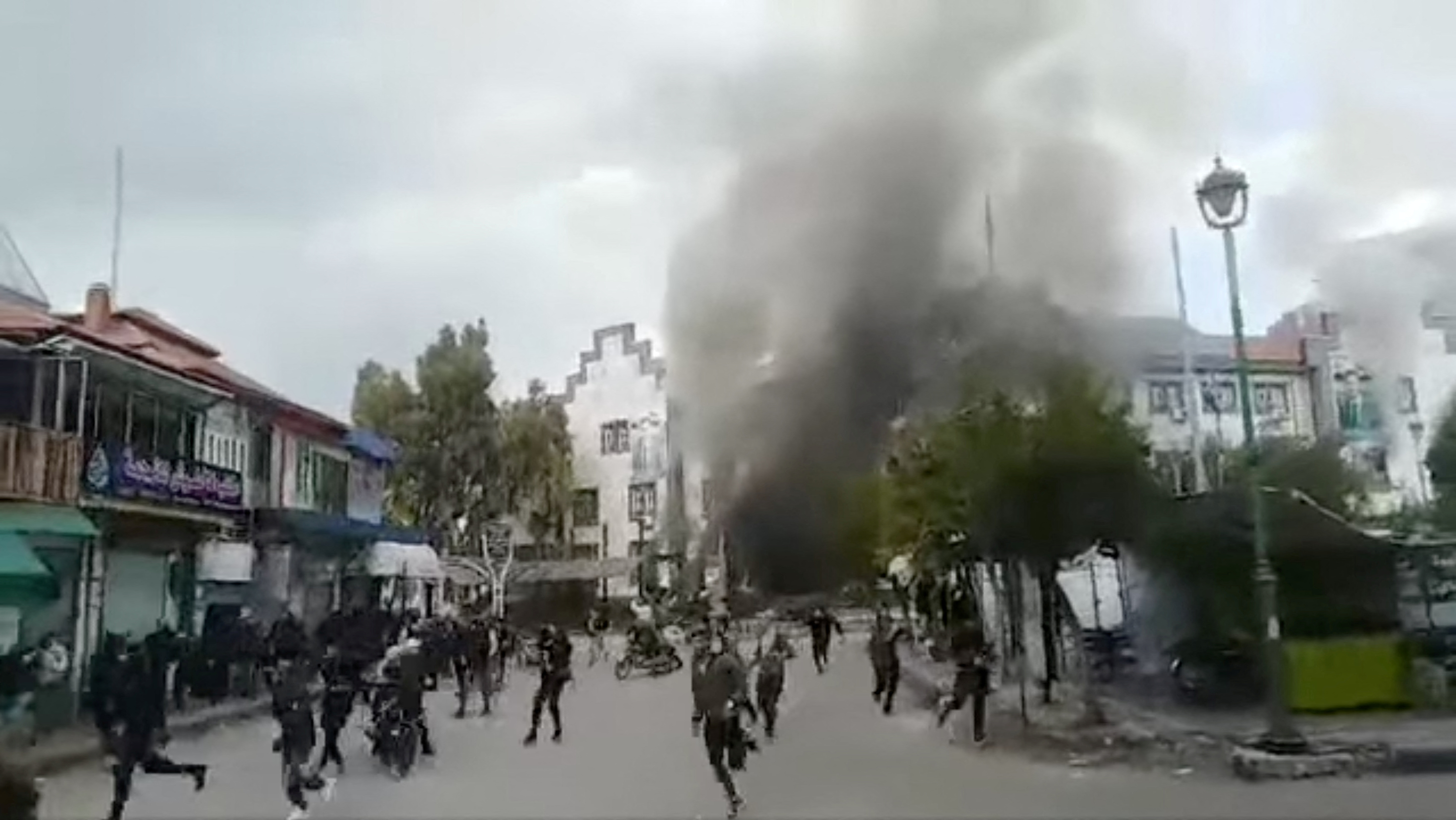 People clash with security forces during a protest in Sweida, Syria.