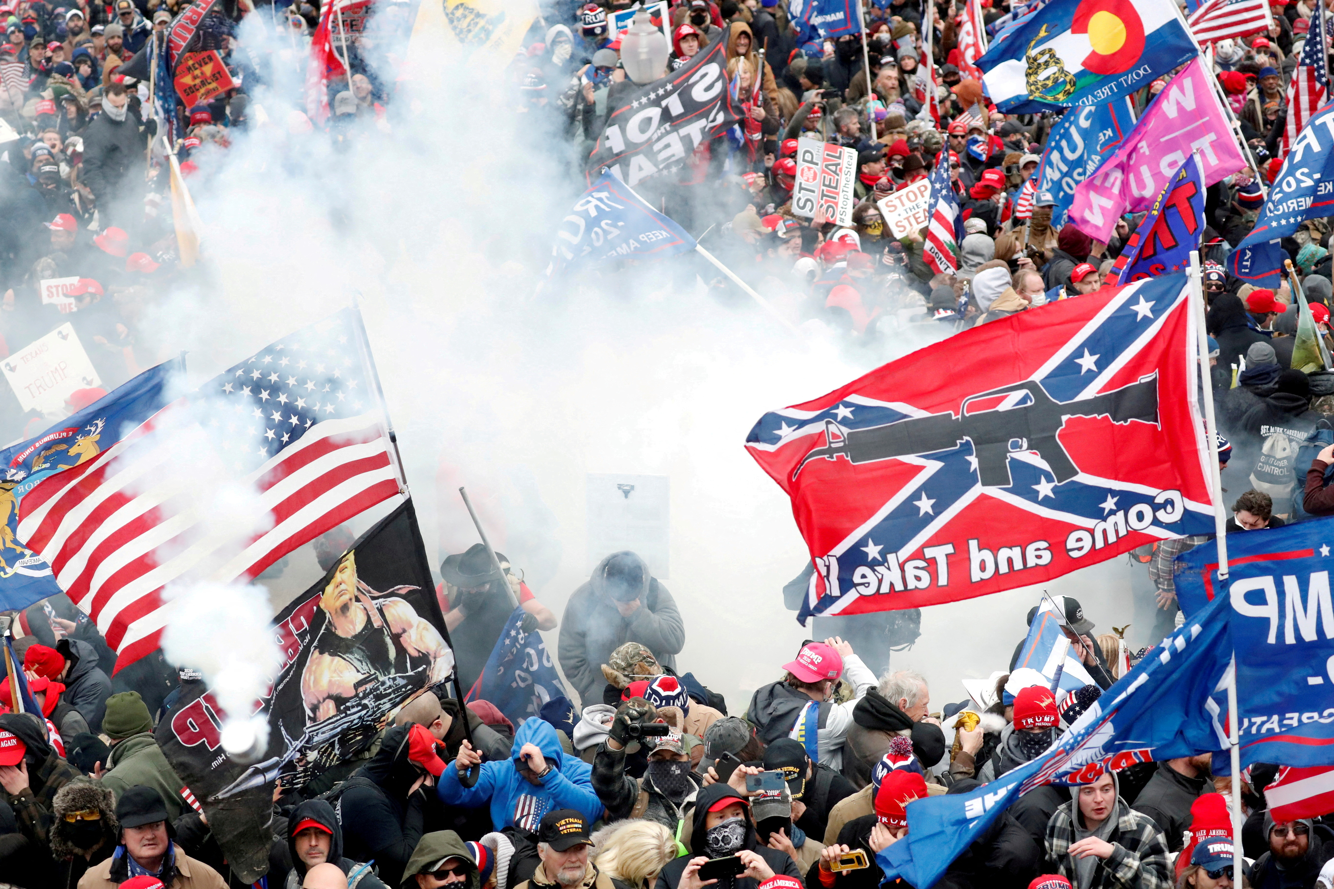 Tear gas is released into a crowd of protesters during clashes with Capitol police at the US Capitol Building in Washington, DC, on January 6, 2021