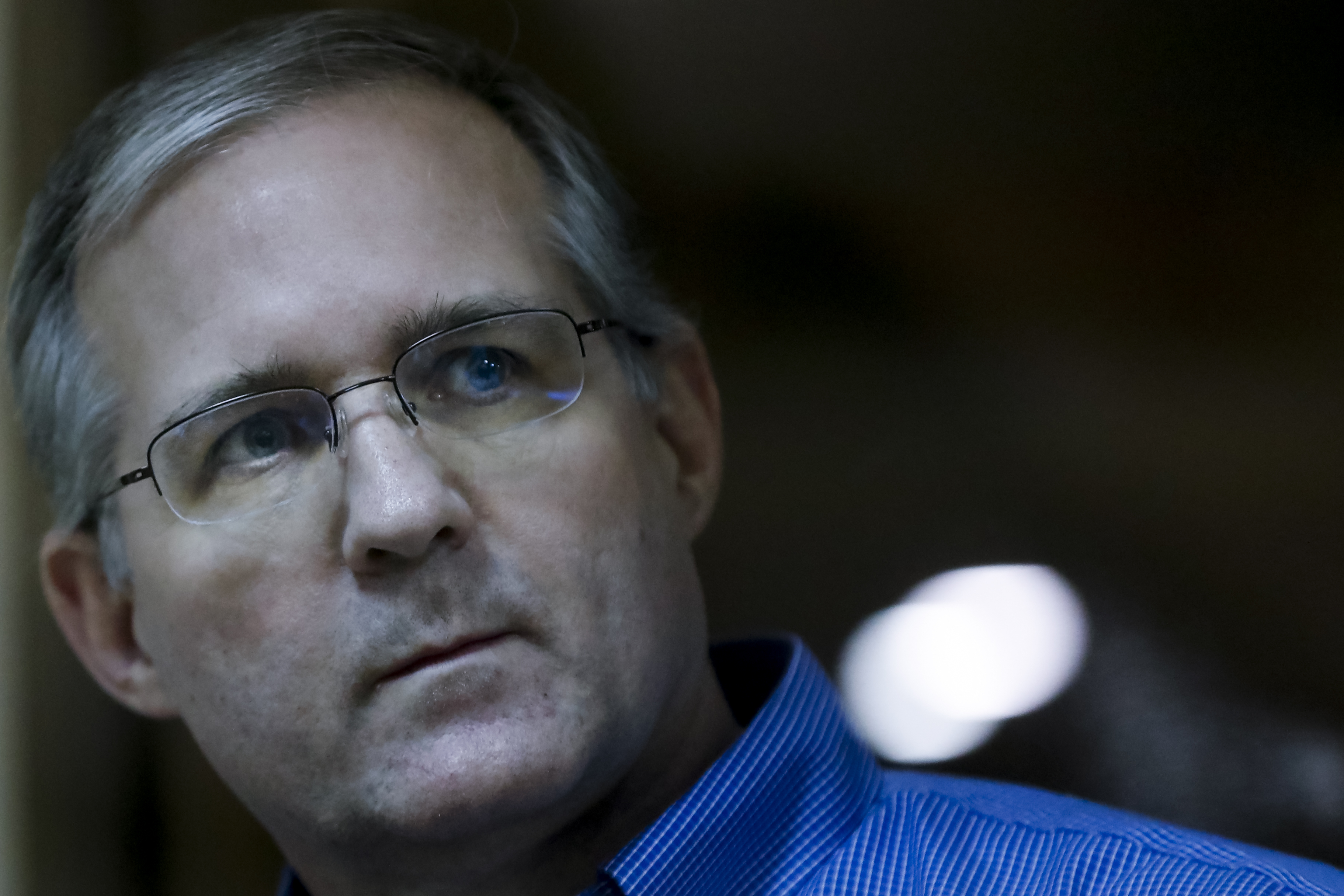 Paul Whelan looks through a glass cage in a Russian court room