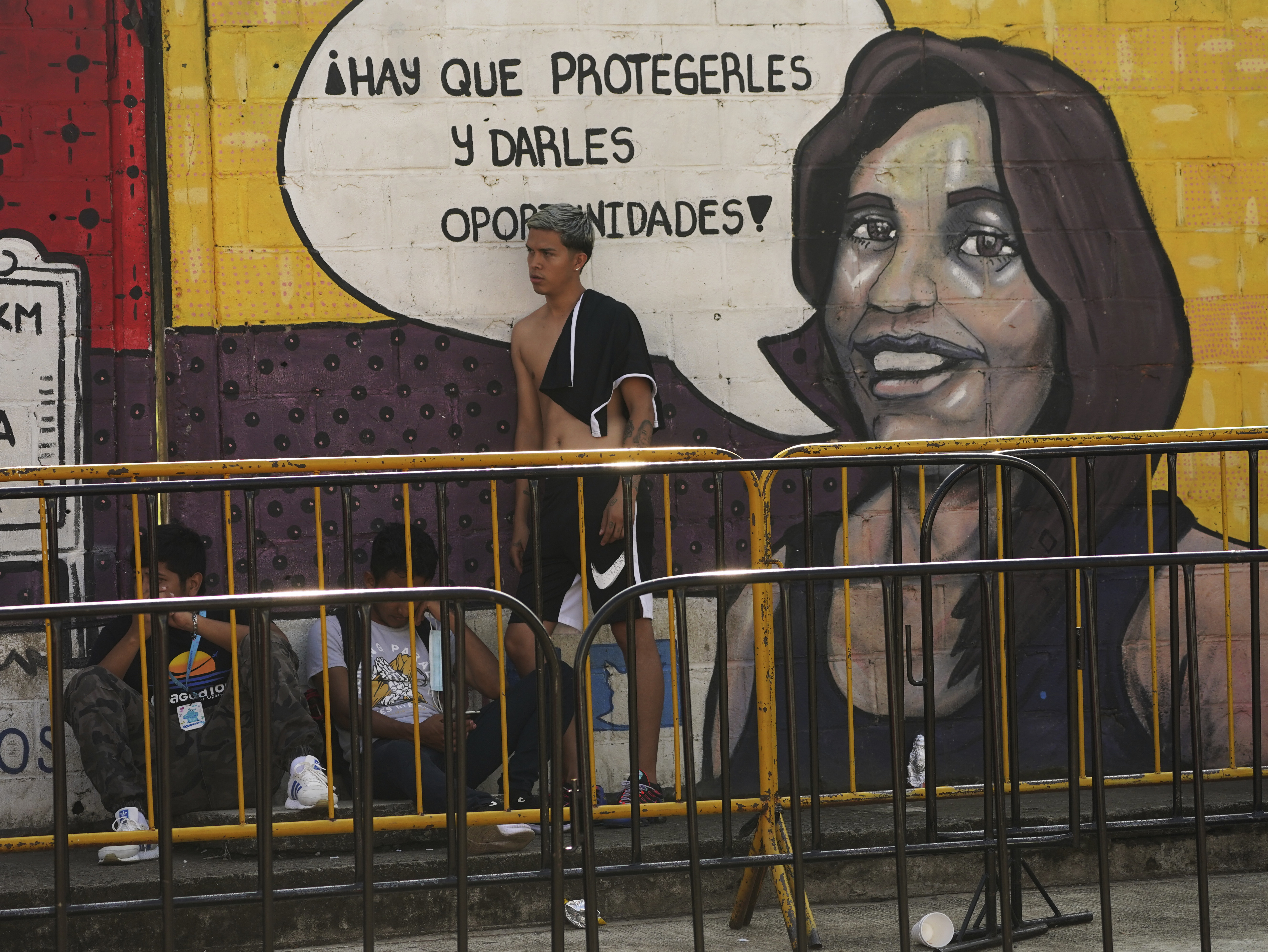 Migrants wait to apply for legal migration permits