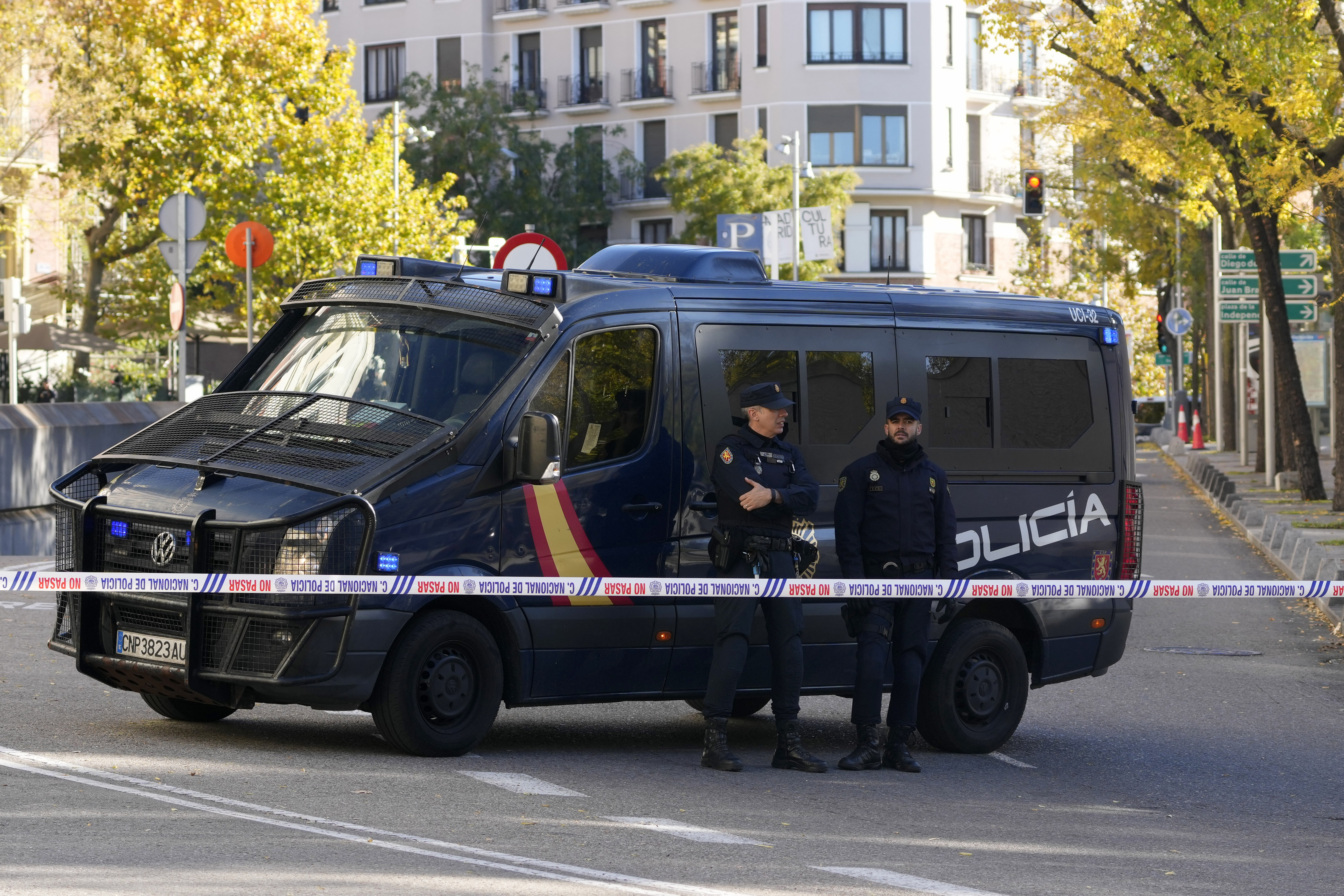 Police officers stand guard as they cordon off the area next to the US embassy in Madrid