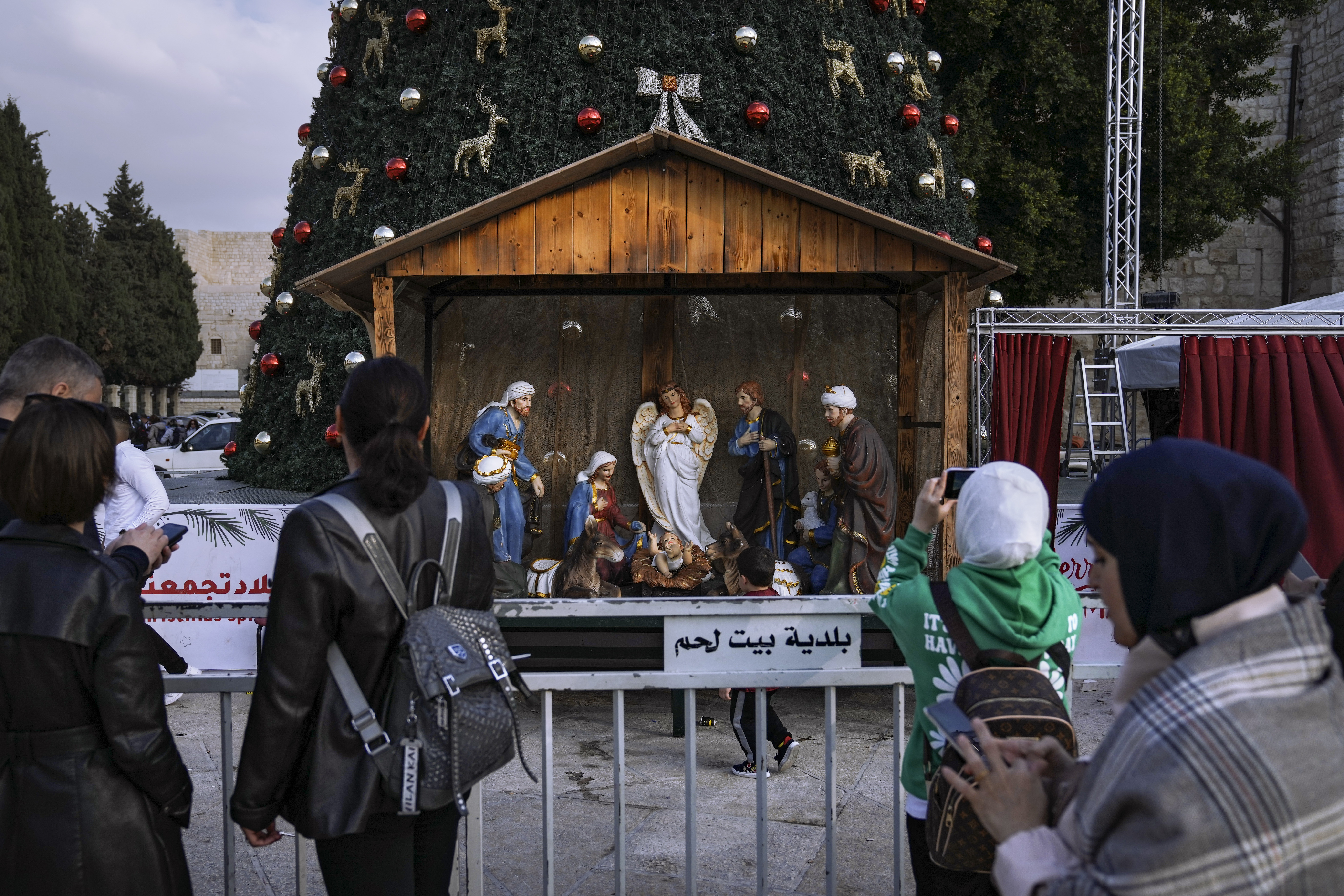 People take pictures of the Christmas tree