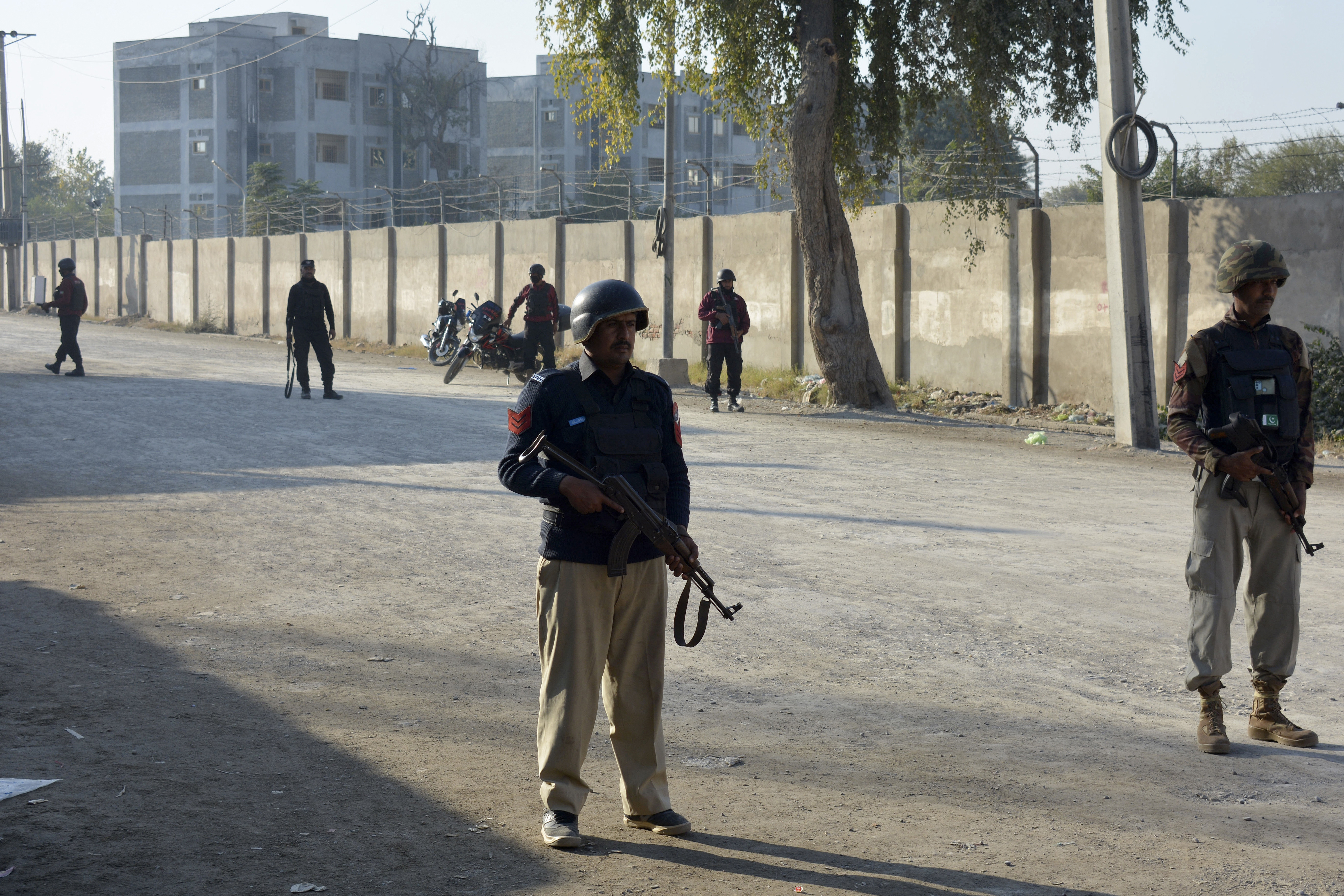 Security officials guard a blocked road leading to the counterterrorism centre