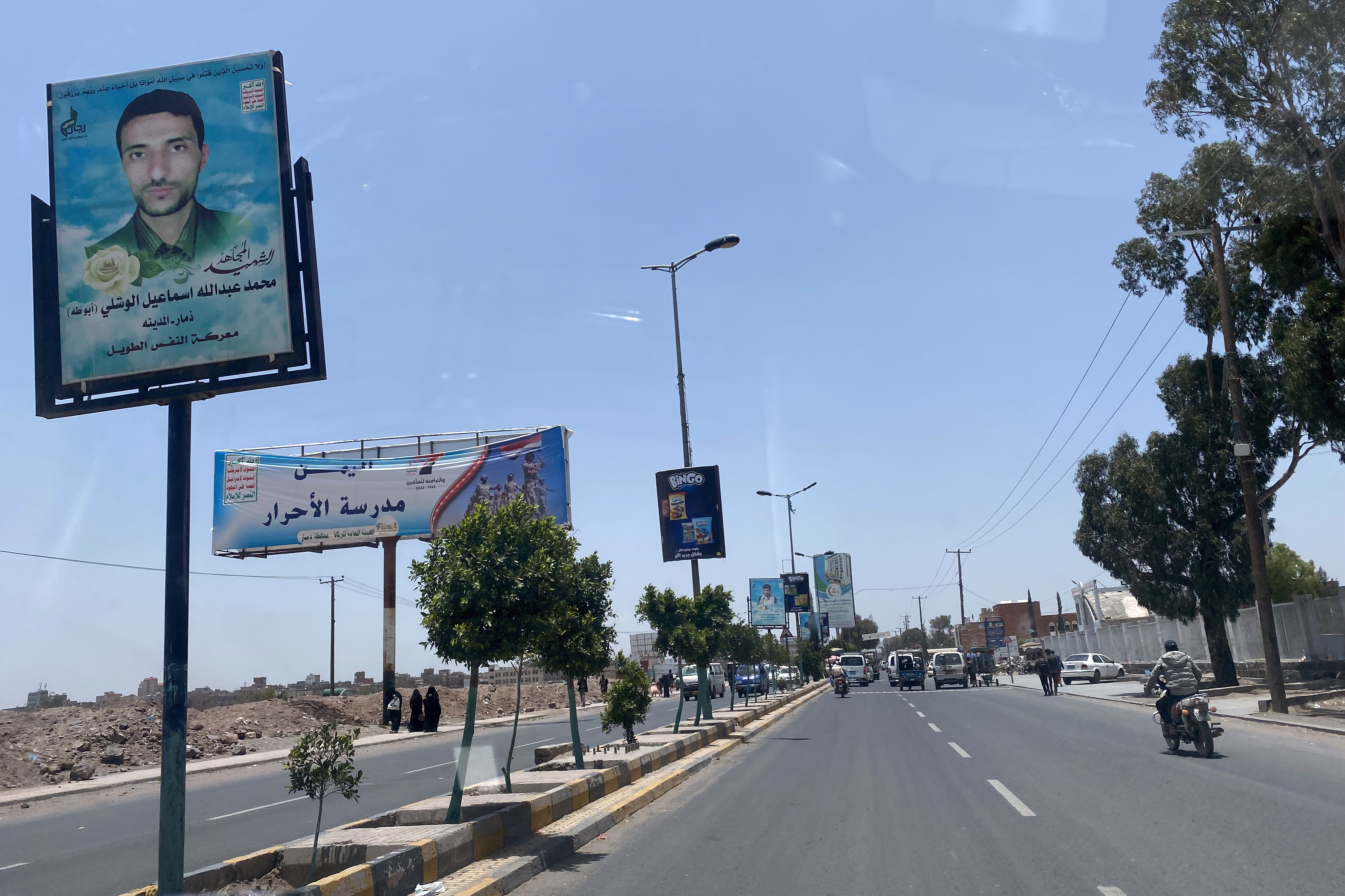 Empty road with a face on a poster