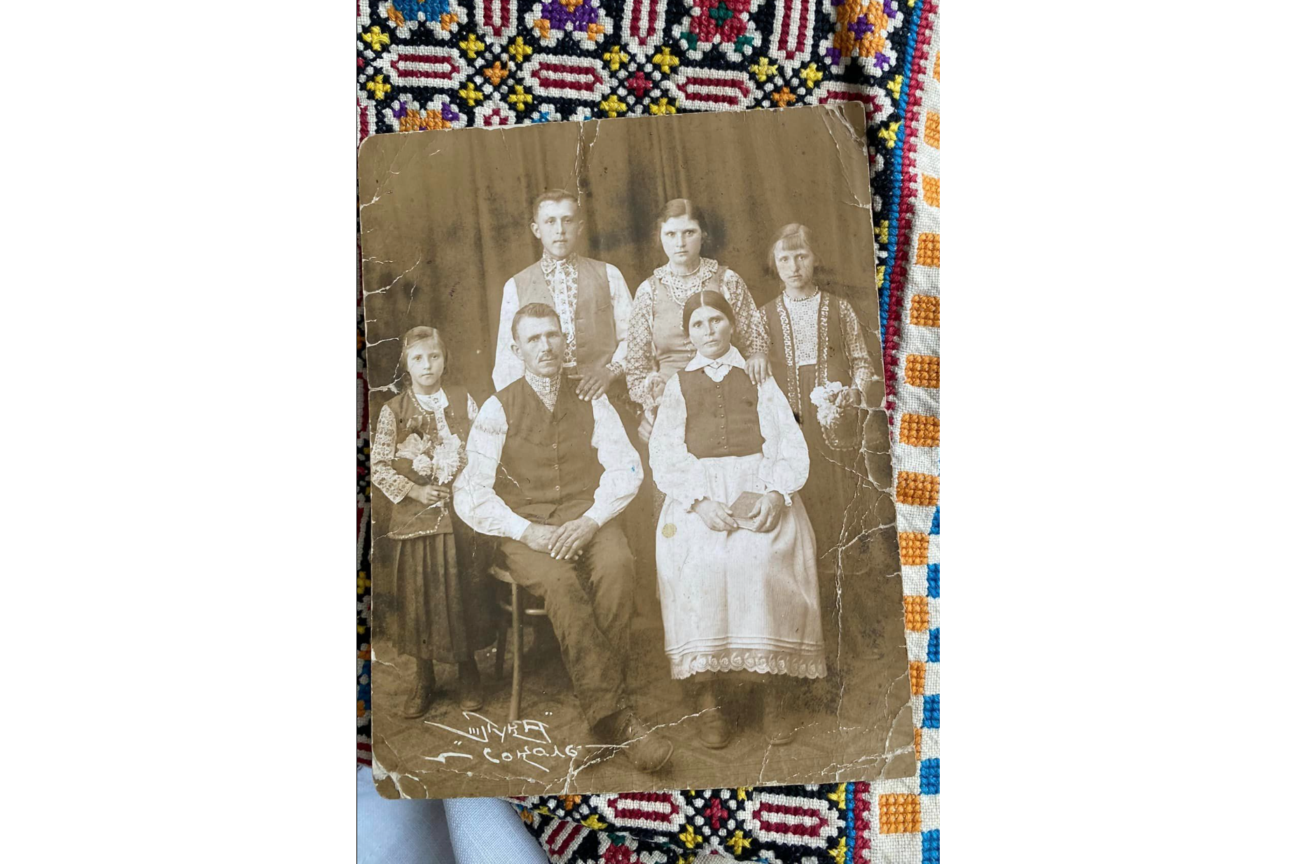 An old embroidered textile featuring blue and yellow threads forbidden during the Soviet era and an old portrait of a Ukrainian family dressed in traditional vyshyvankas were some of the items recently evacuated by Lesia Voroniuk and her team [Photo courtesy Lesia Voroniuk]