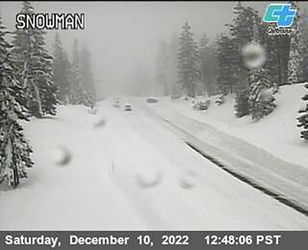 Heavy snow blankets a road in California on Saturday [Caltrans via AP]