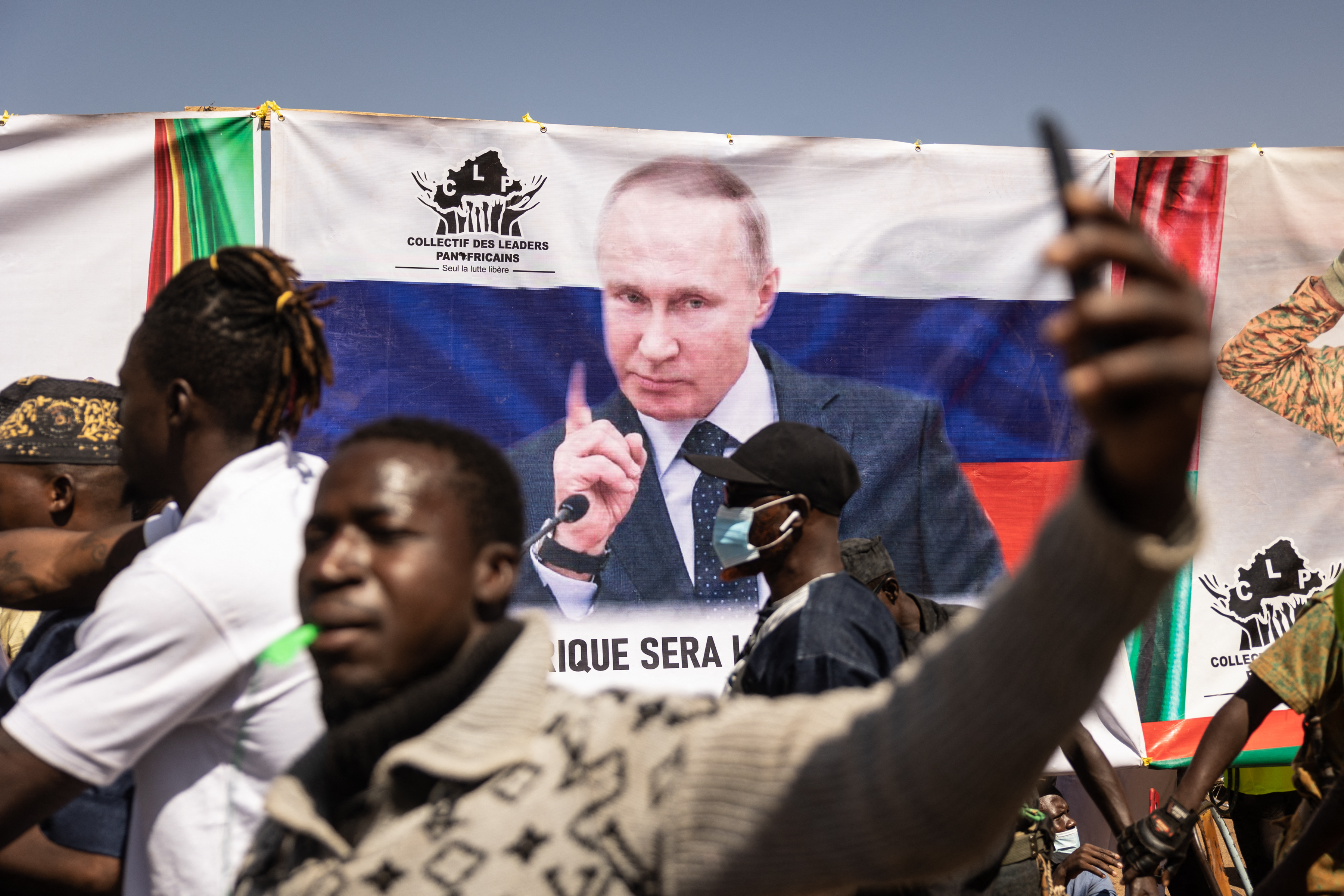 A banner of Russian President Vladimir Putin is seen in Burkina Faso’s capital during a demonstration to demand the departure of France’s ambassador and military forces, in Ouagadougou, Burkina Faso, on January 20, 2023 [Olympia de Maismont/ AFP].