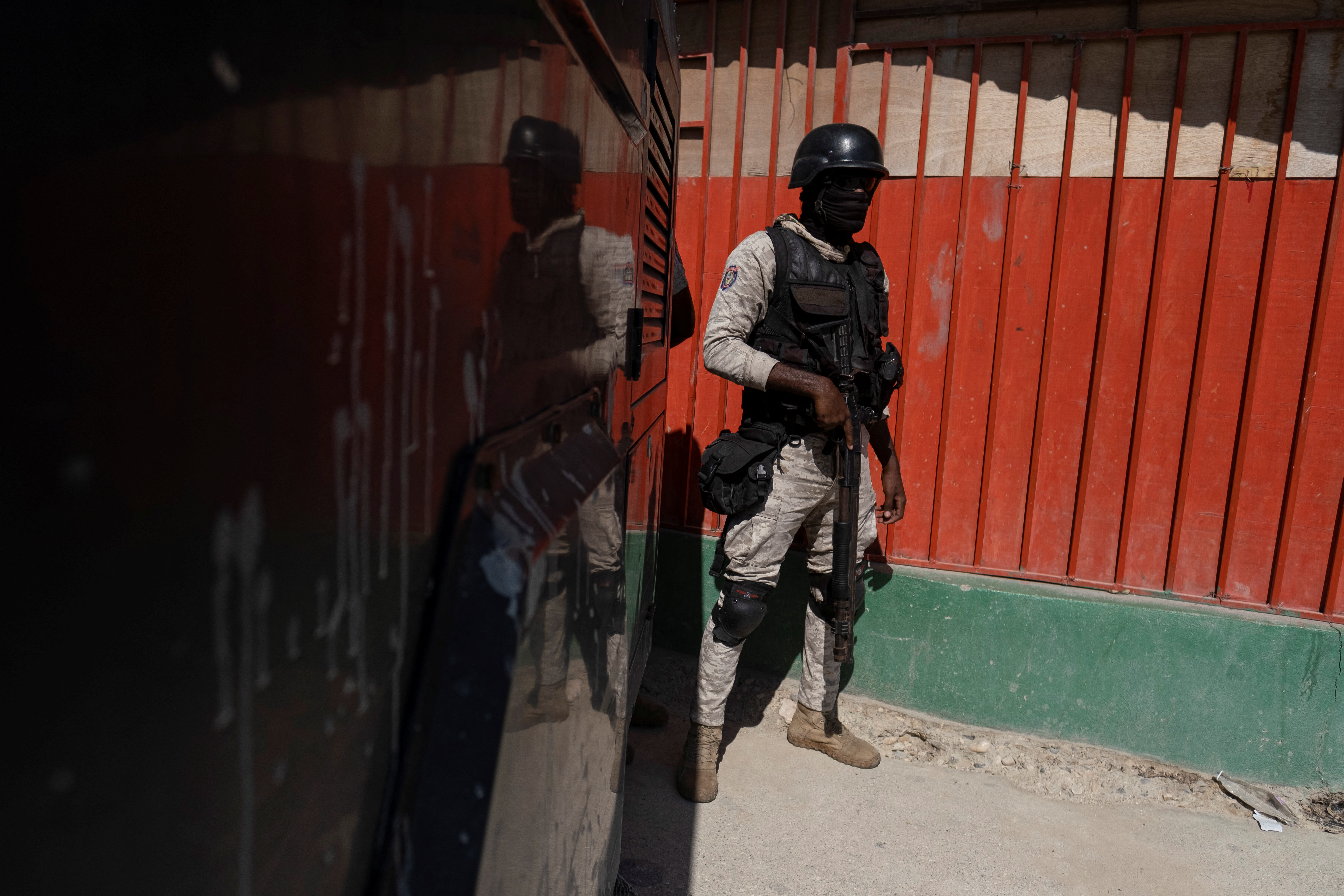 A Haitian National Police officer stands guard