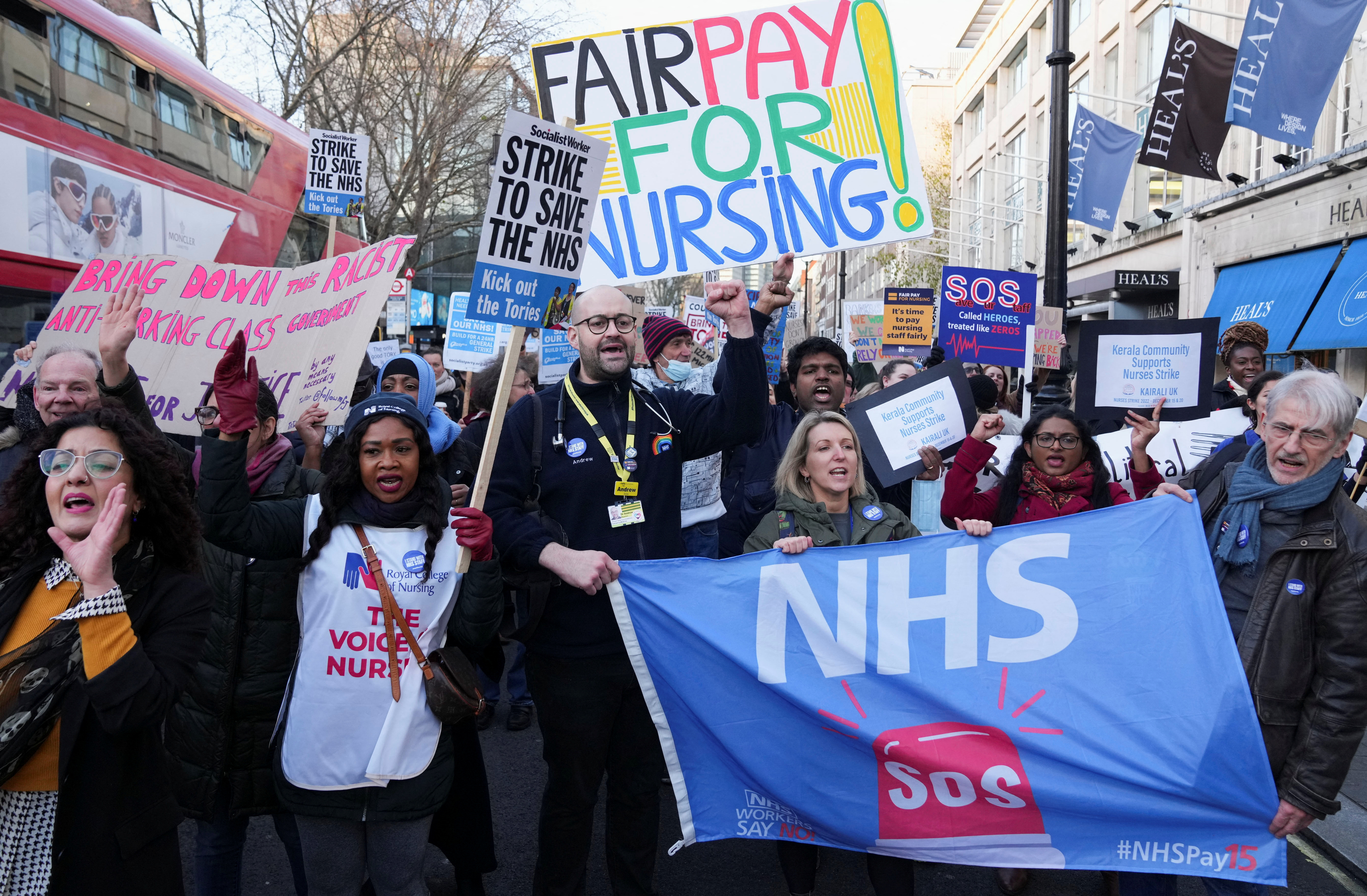 NHS nurses hold signs during a strike, amid a dispute with the government over pay, in London, Britain December 20, 2022.