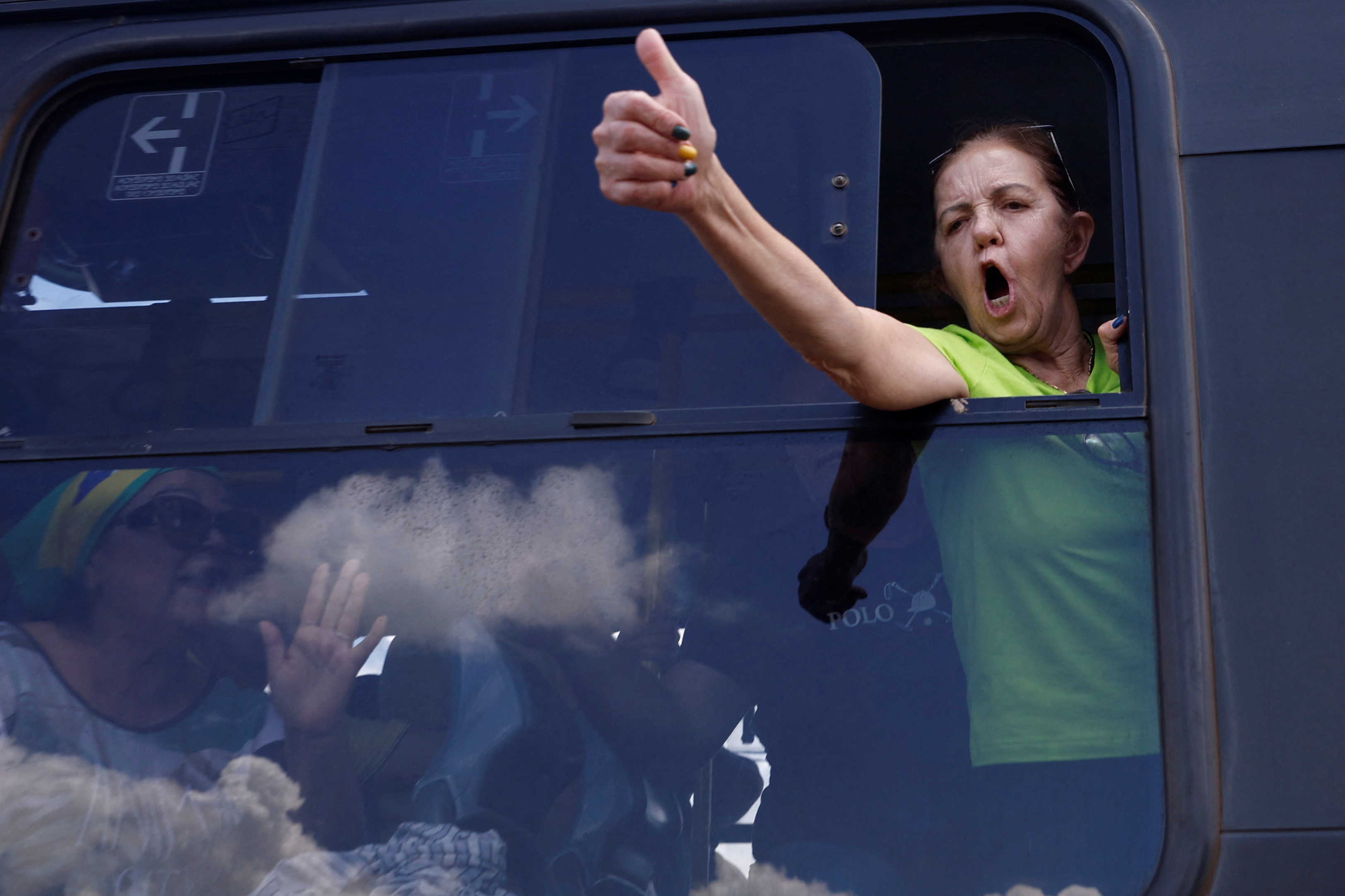 Supporters of Bolsonaro board a bus after their camp in front of army headquarters in Brasilia was dismounted on January 10, 2023
