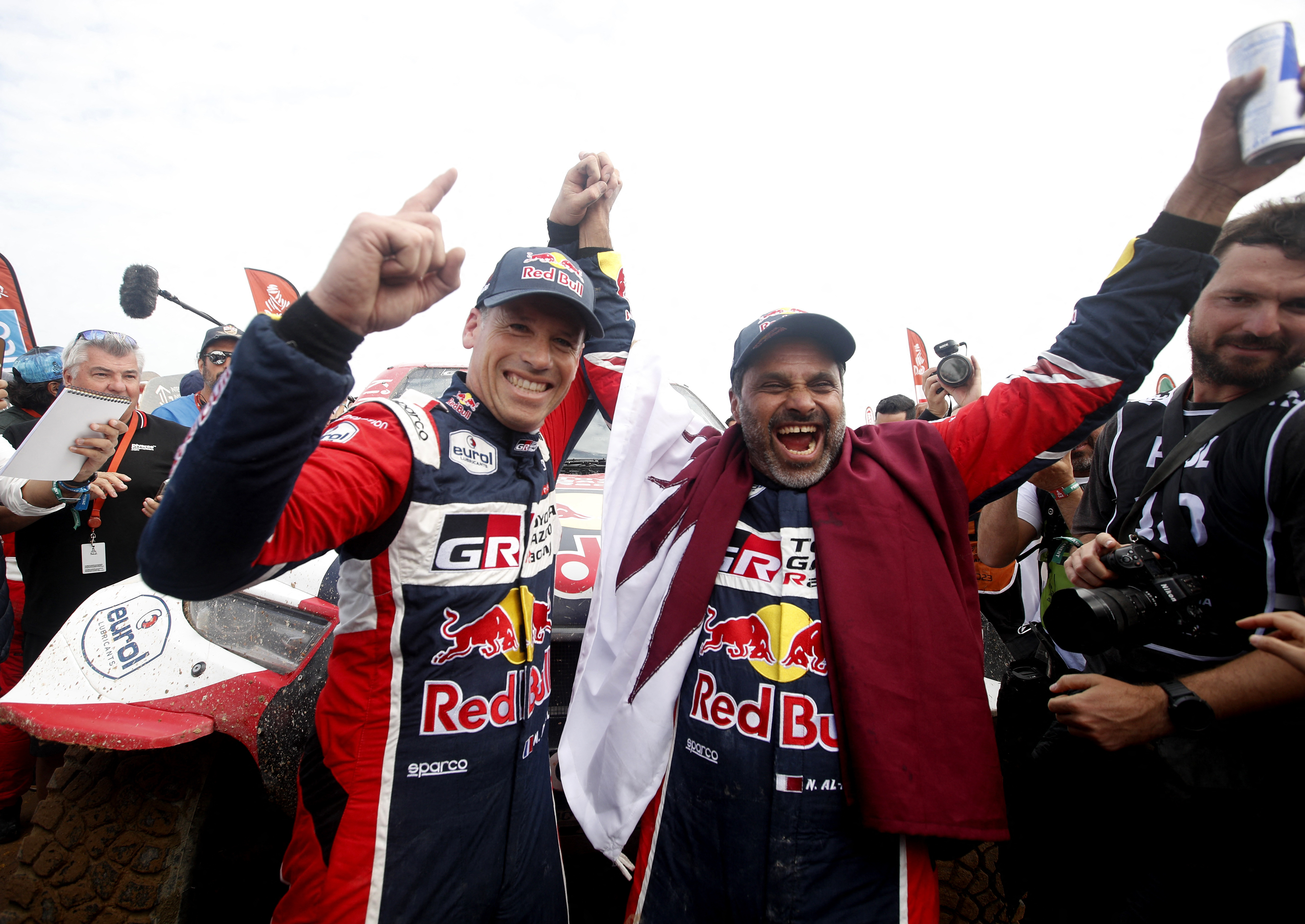 Toyota Gazoo Racing’s Nasser al-Attiyah, right, and co-driver Mathieu Baumel celebrate winning the car category