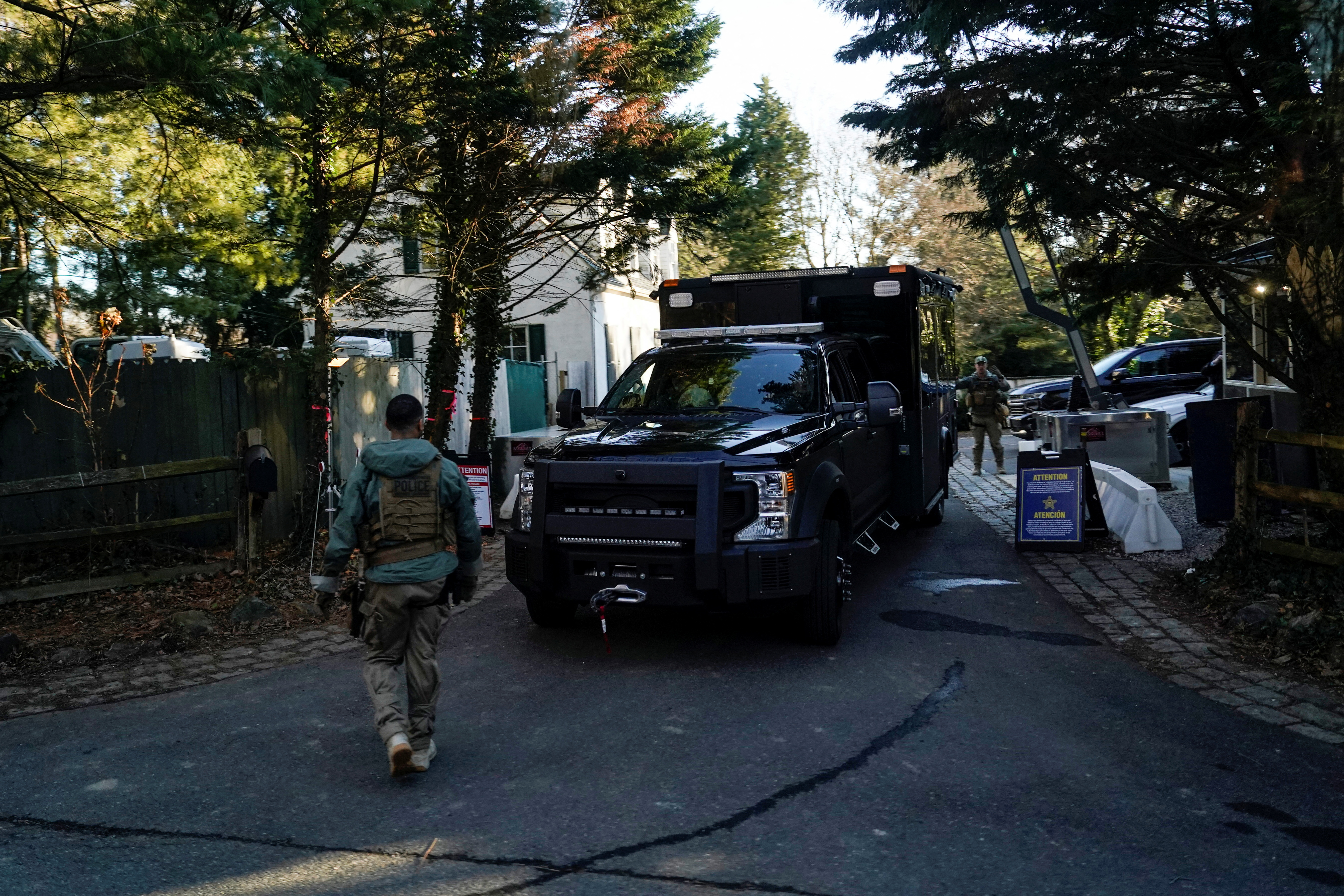 Secret Service personnel park vehicles outside President Joe Biden's residence in Delaware