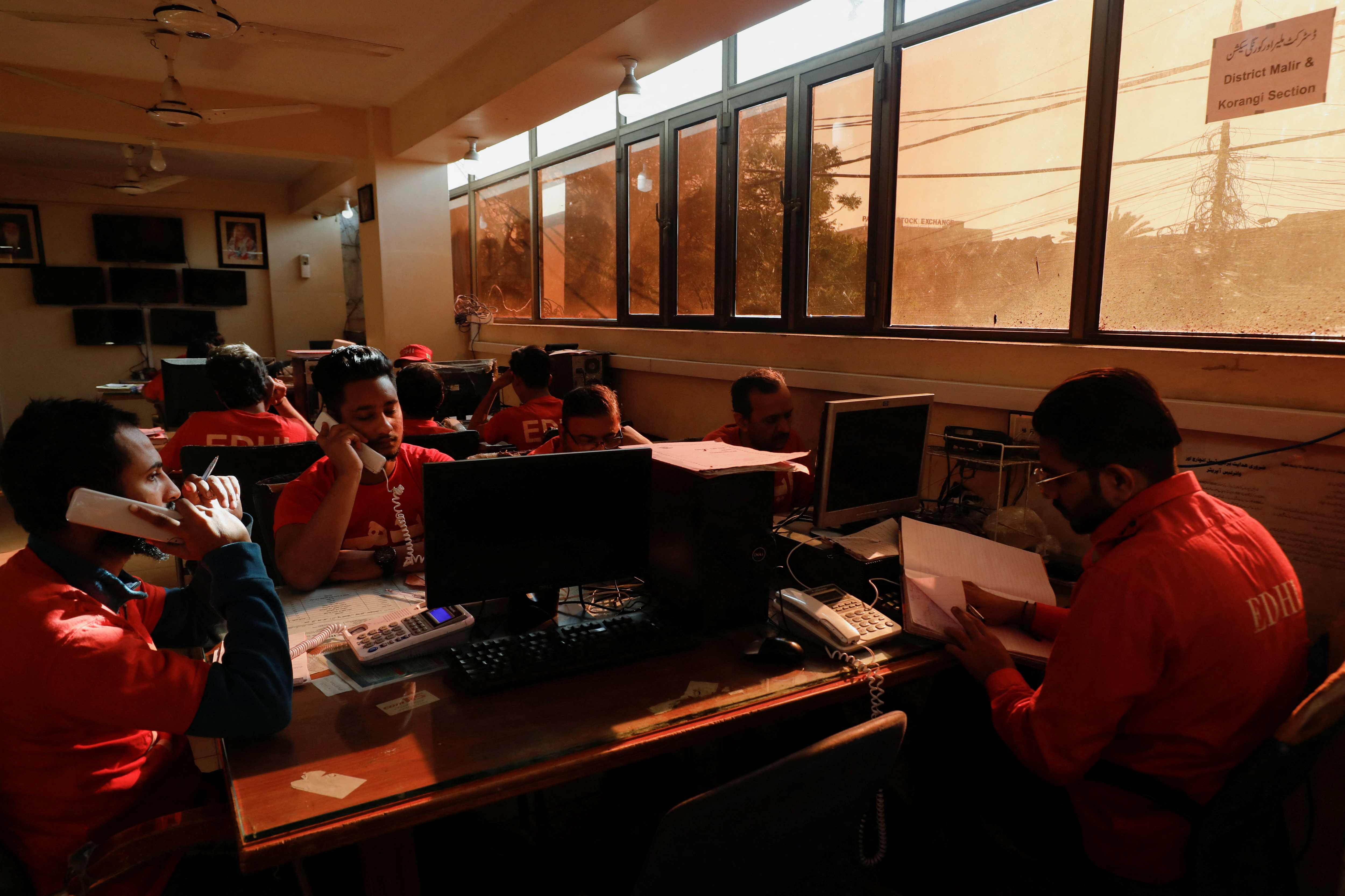 Volunteers of the Edhi Foundation, a non-profit social welfare programme, work at a communication and control room during the power breakdown in Karachi