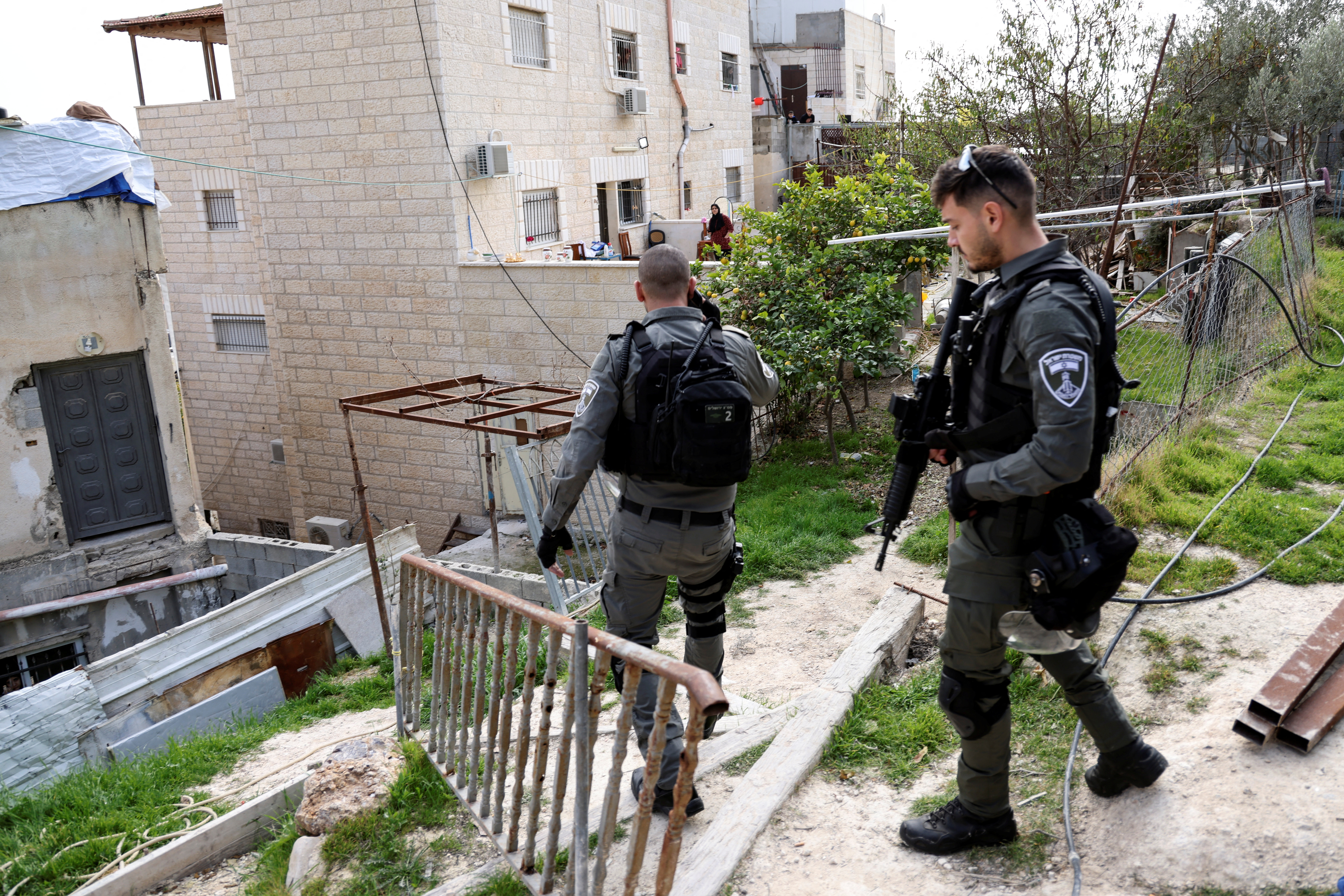 Israeli border police officers walk by the family home of Palestinian gunman Khaire Alkam as it is sealed off, after he killed people in a synagogue attack on the outskirts of Jerusalem, in A-Tur, East Jerusalem January 29, 2023. REUTERS/Ammar Awad
