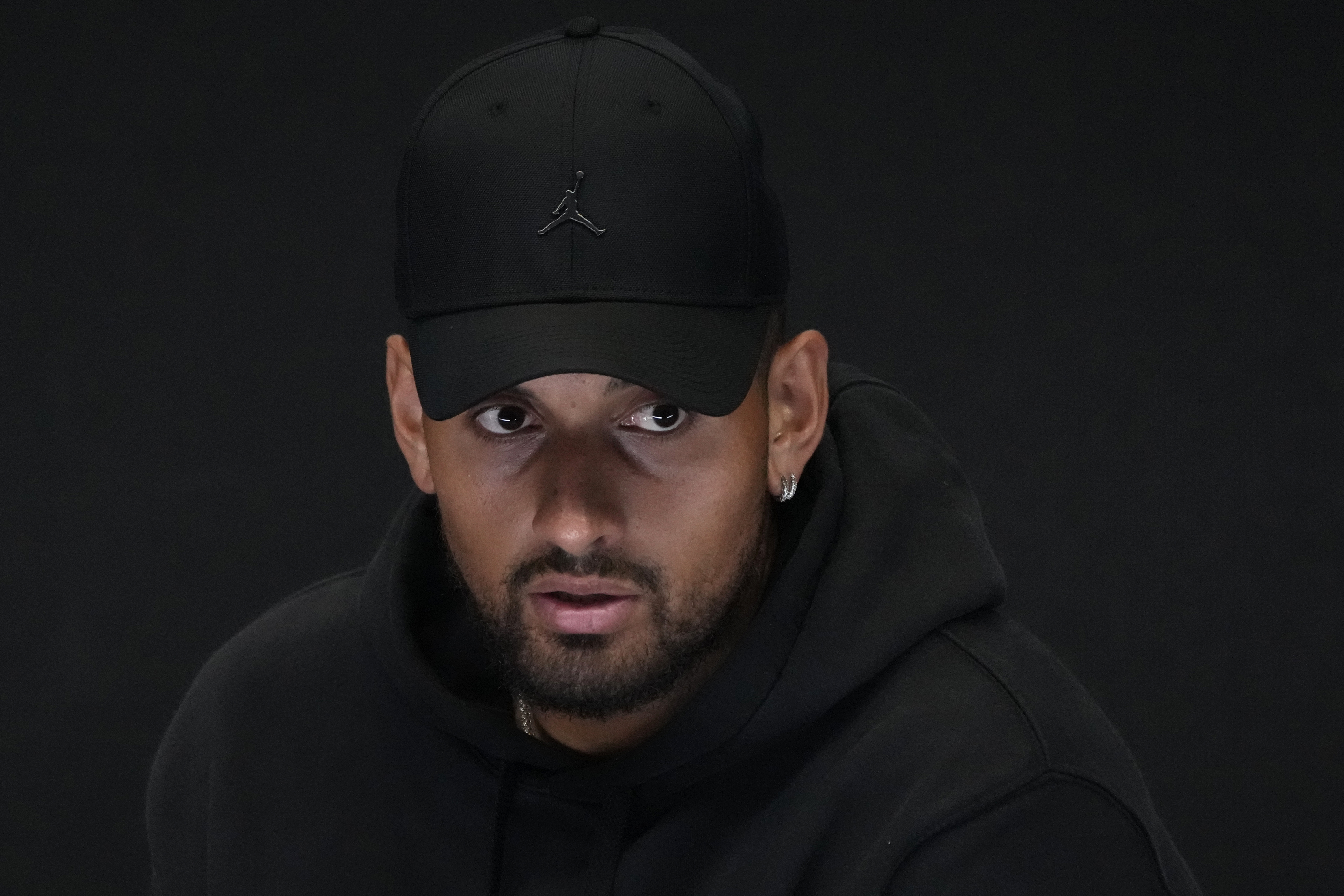 Australia's Nick Kyrgios reacts as he announces his withdrawal from the Australian Open with a knee injury at a press conference in Melbourne, Australia, Monday, Jan. 16, 2023. (AP Photo/Mark Baker)