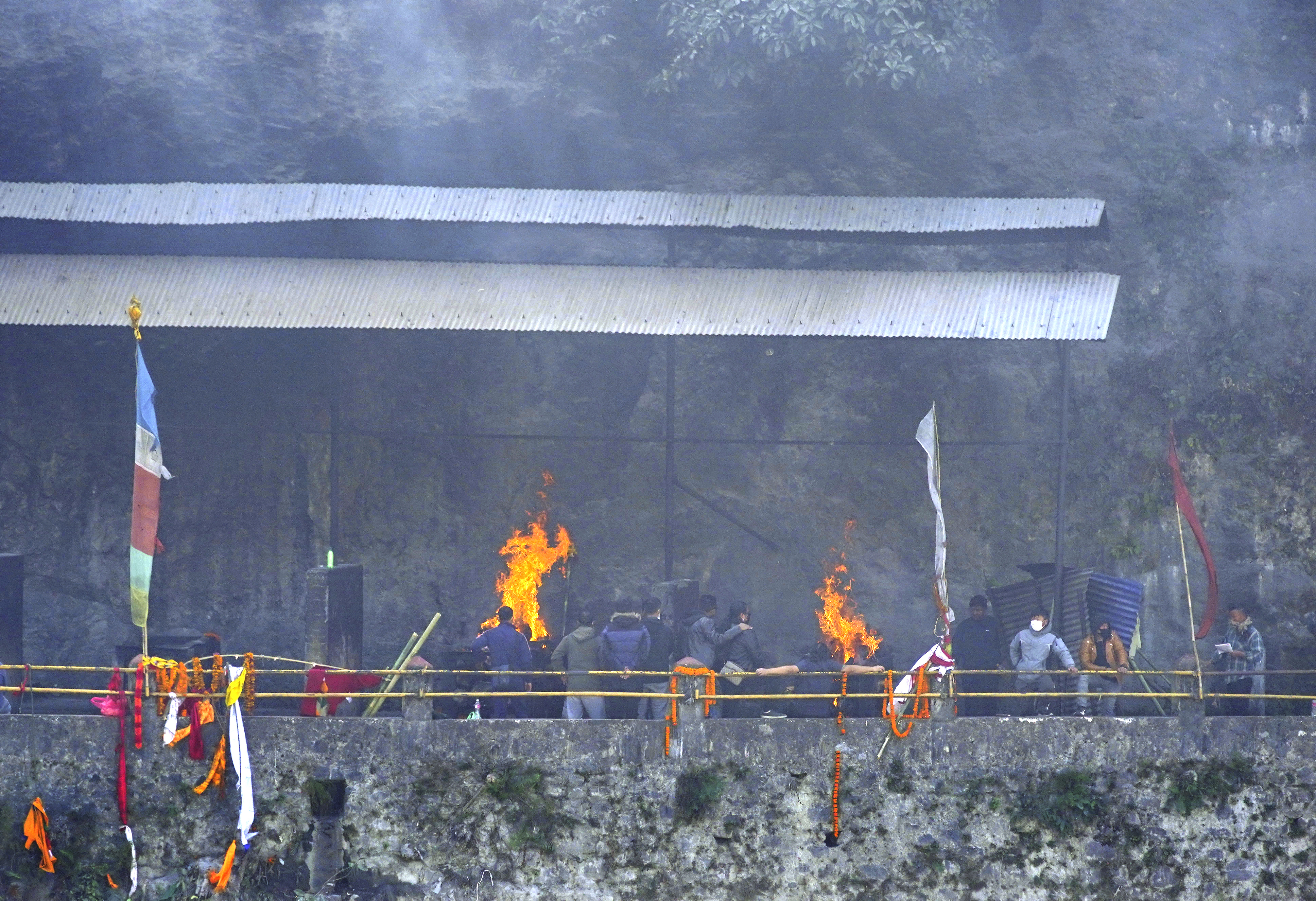 Relatives and friends perform the last rites for the plane crash victims in Pokhara, Nepal