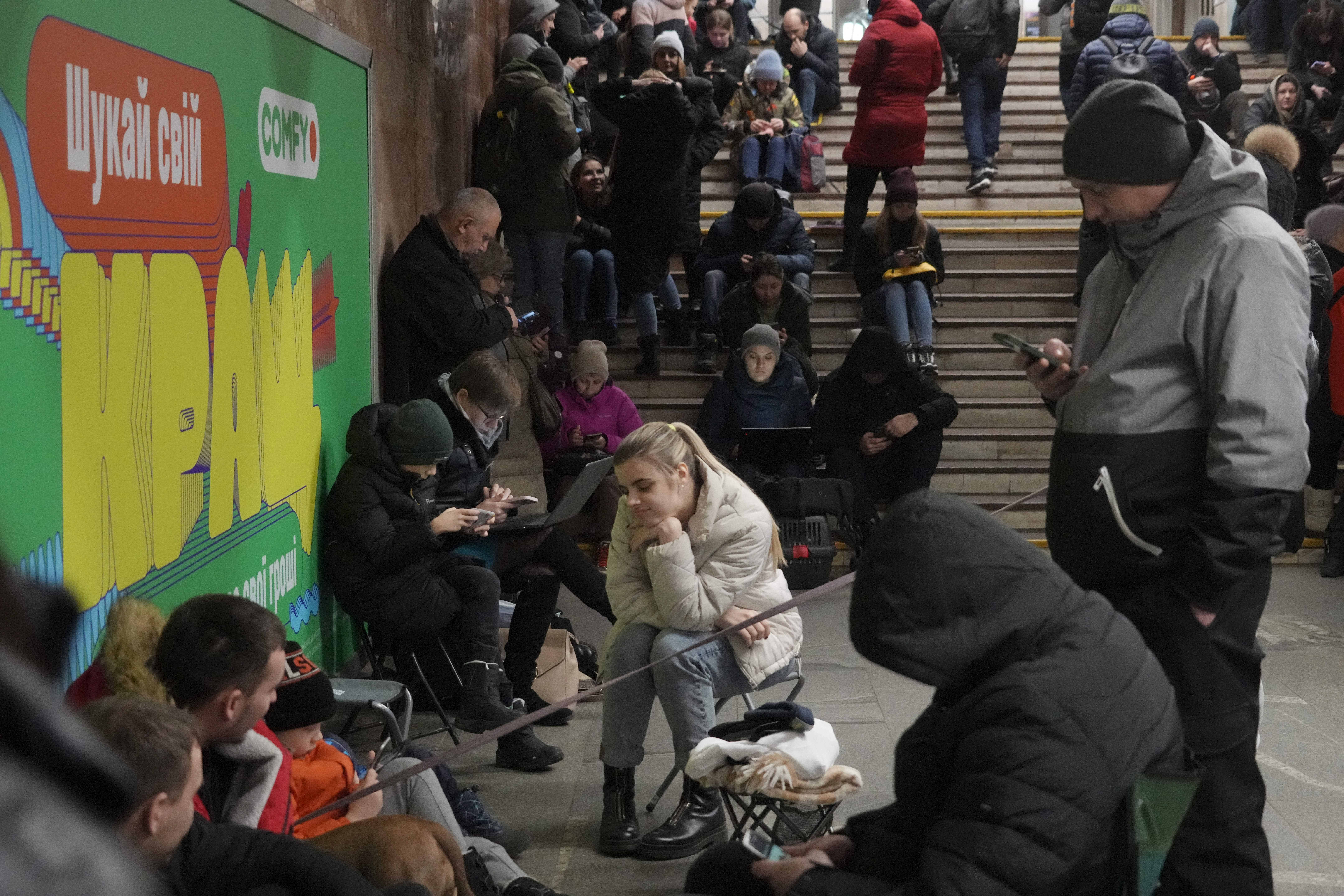 People take shelter in a subway station during a rocket attack in Kyiv