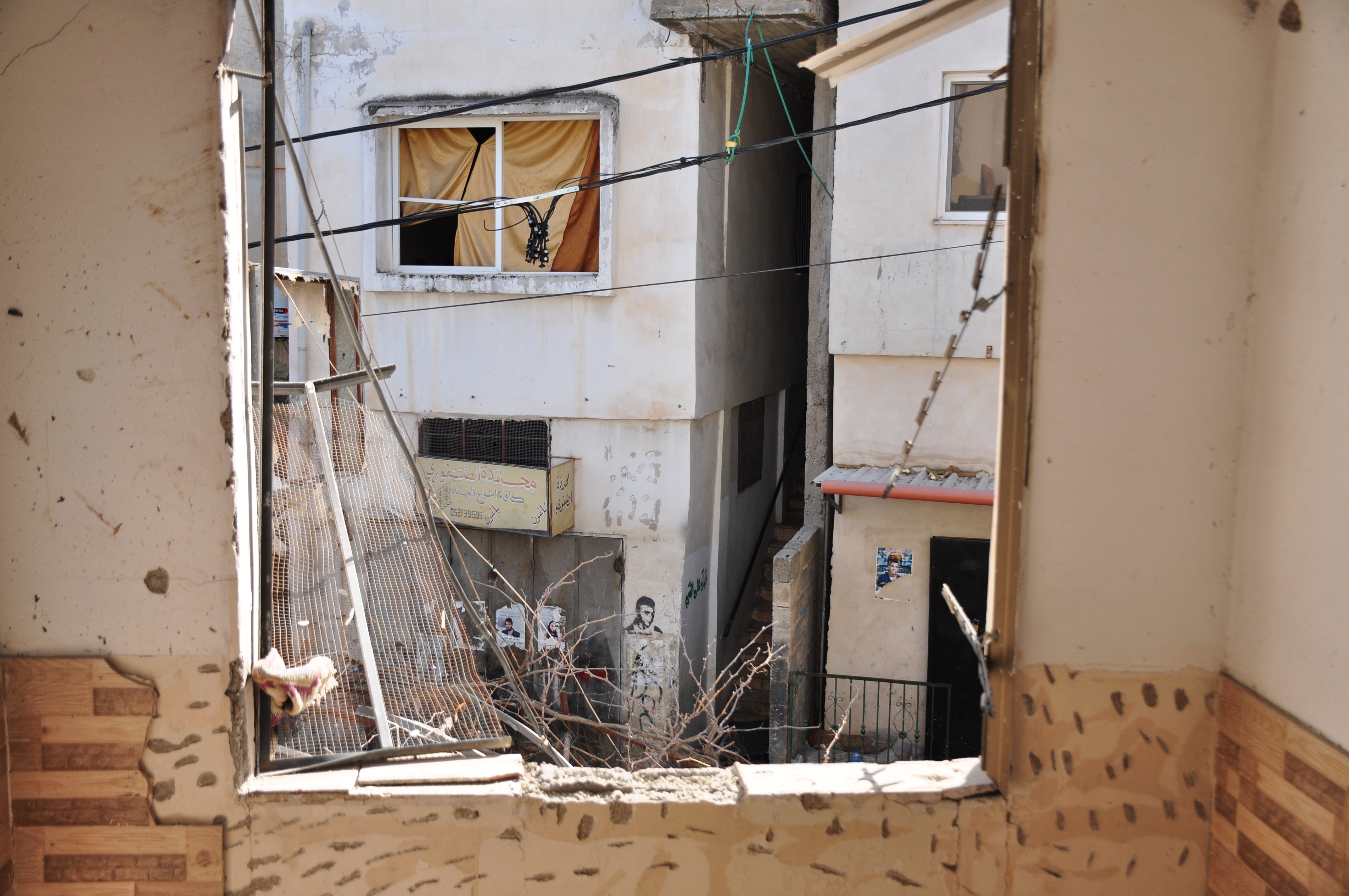 The destroyed home where three known Palestinian fighters were taking shelter when Israel attacked it with surface-to-air missiles, causing it also to set on fire.