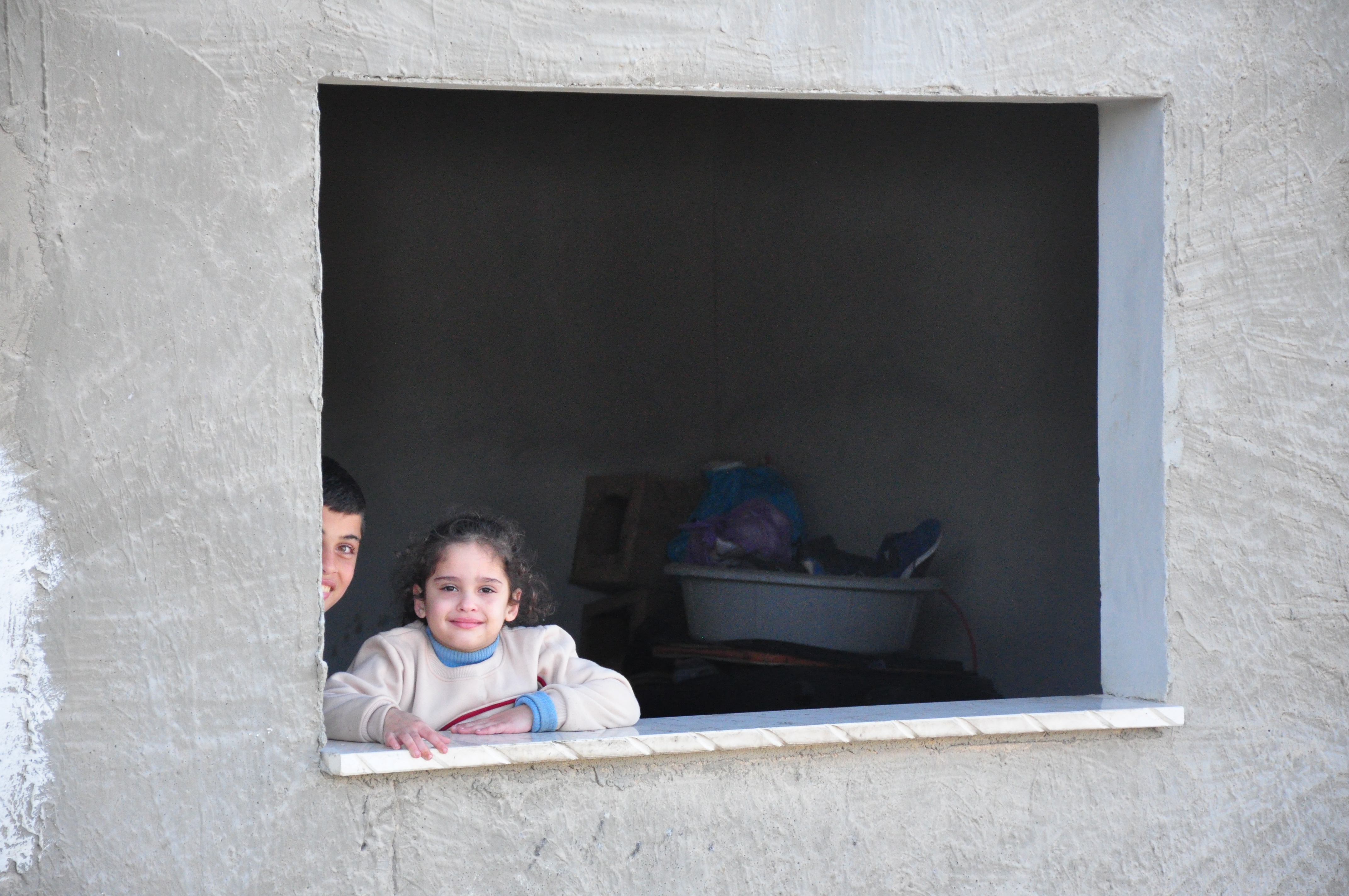 The children of Diana Qreini, whose home was hit with bullets from several directions during the raid