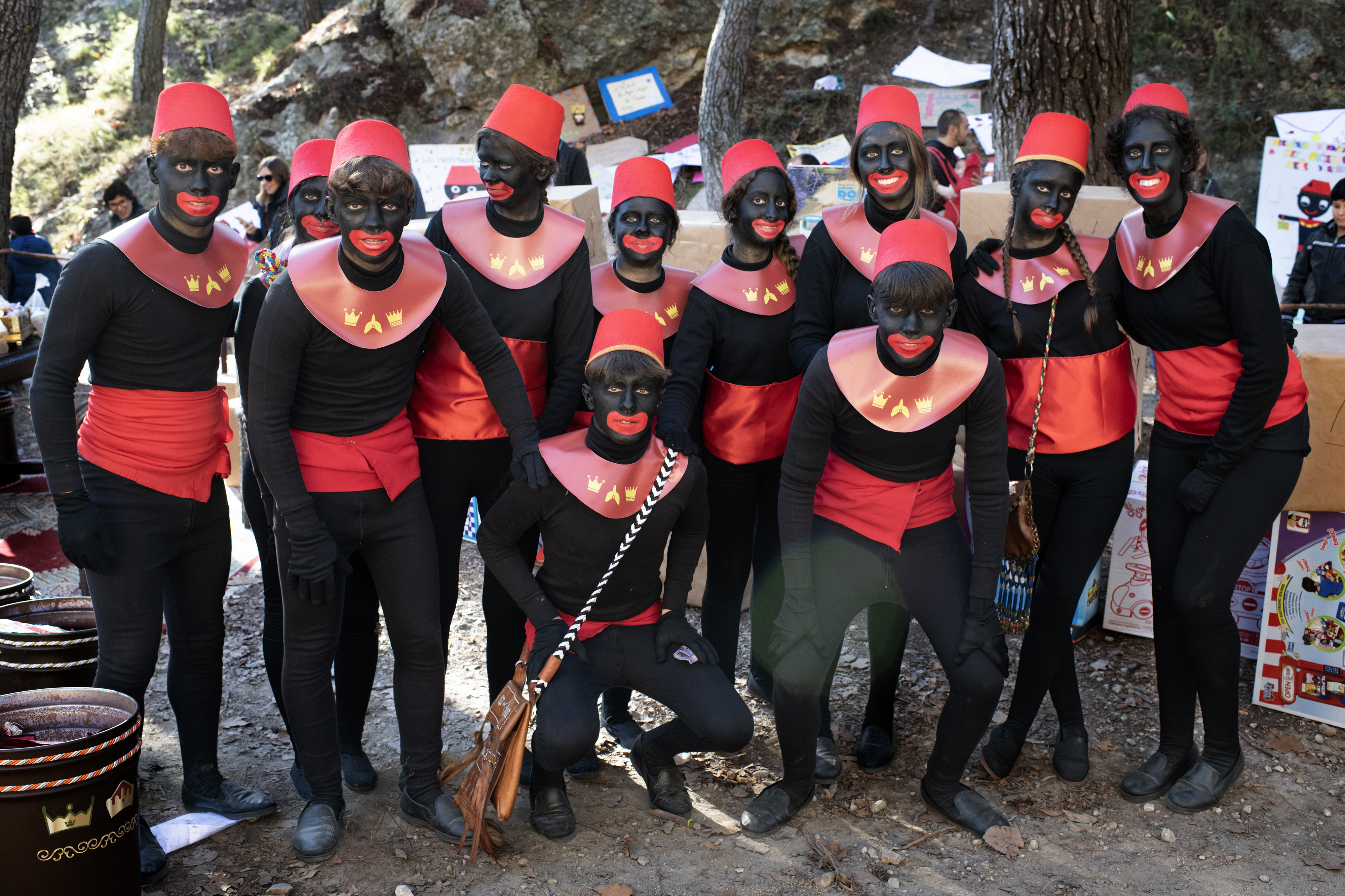 Blackface pageboys and girls pose on the outskirts of Alcoy while organising presents for the night ahead
