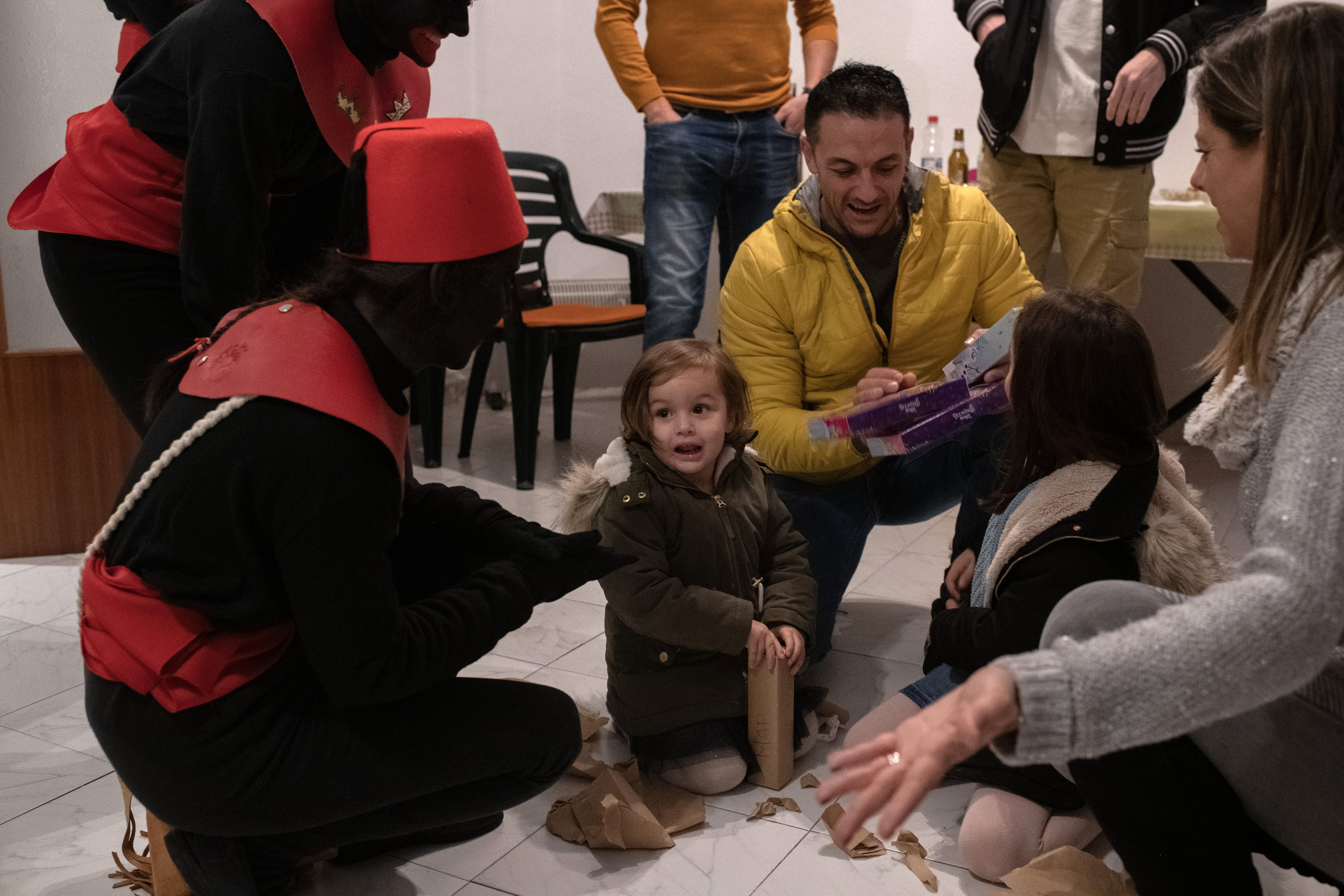 Spanish children open Christmas presents brought by blackface pageboys
