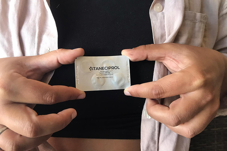 An abortion access organiser in Louisiana holds up a packet of misoprostol obtained via Mexico