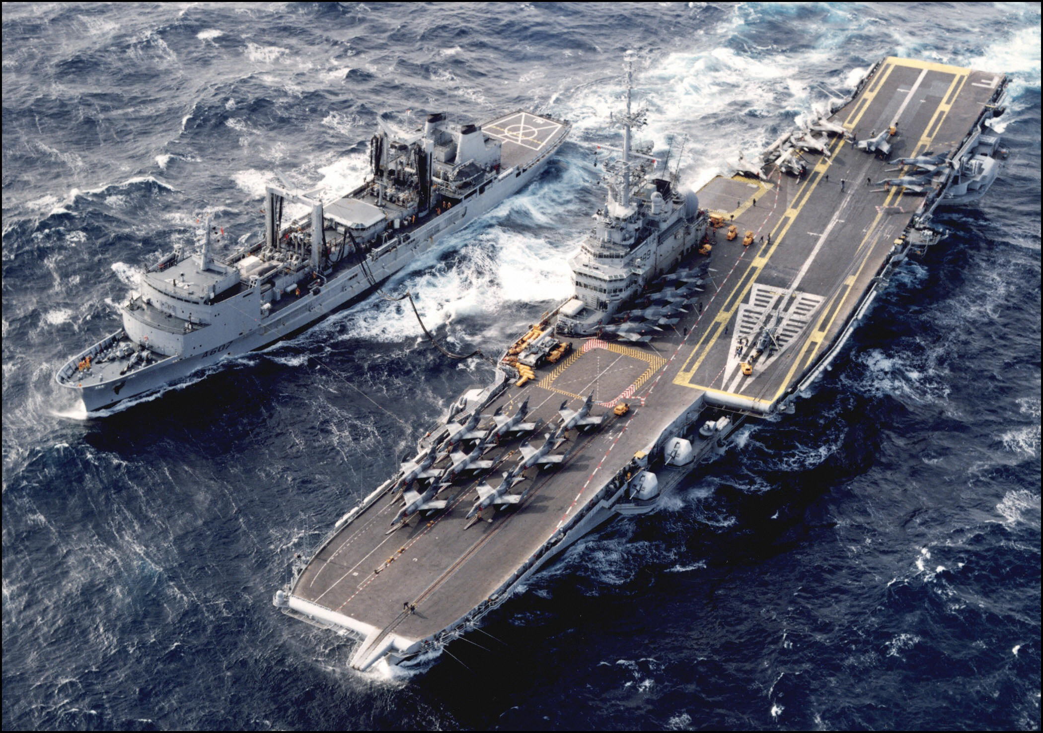 FILES) This file photo taken on February 10, 1994 shows an aerial view of the then French aircraft carrier "Foch", acompanied by the boat cistern "Meuse" at the Adriatic Sea. - The Brazilian Navy sank an old French aircraft carrier that was out of service this Friday February 3, 2023 in the Atlantic Ocean, the military institution reported, in a decision criticized by environmental NGOs that claim the vessel is full of toxic materials. (Photo by AFP)