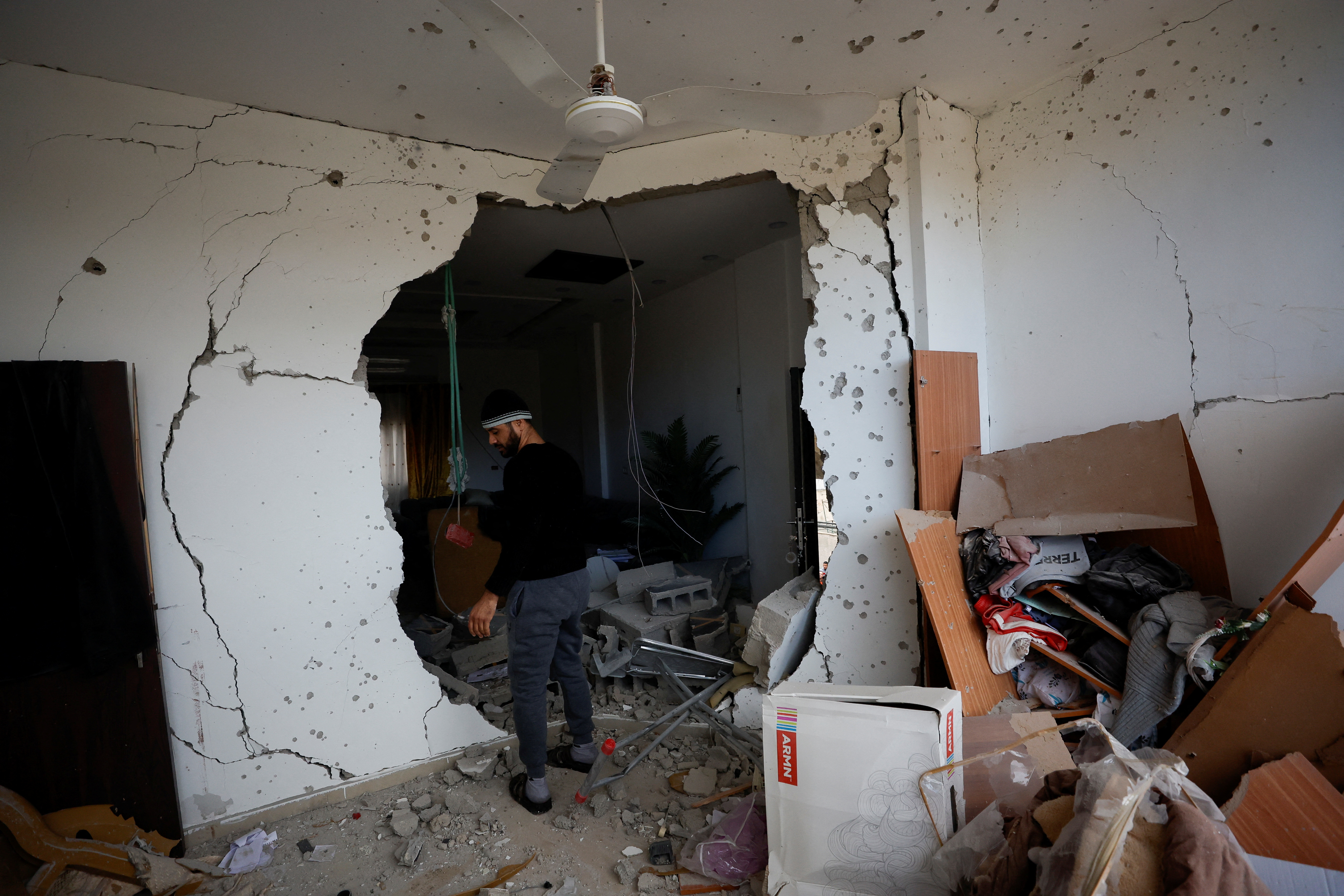 A Palestinian man checks damage in a house, which was destroyed by Israeli troops during the military raid in Jericho.