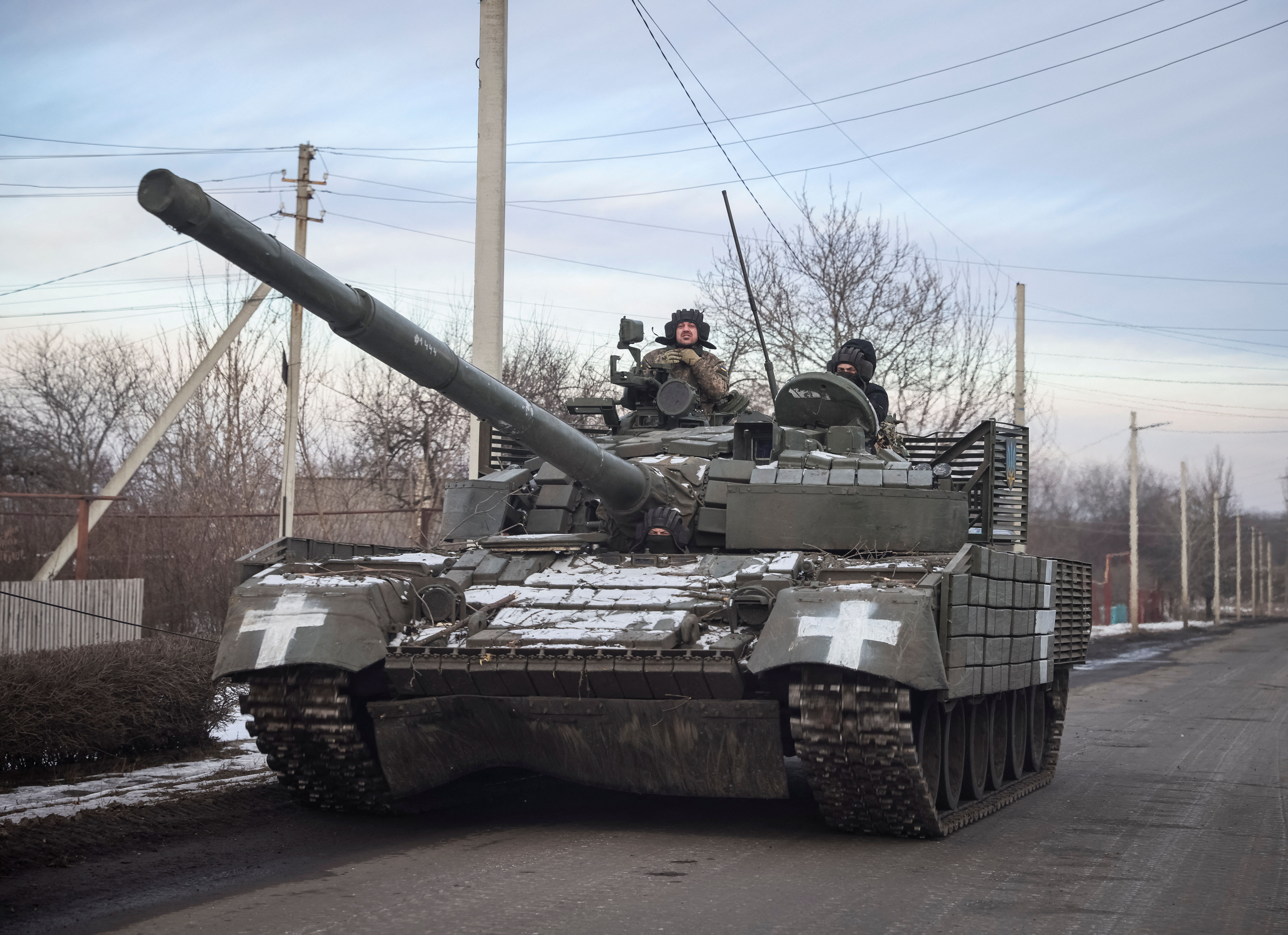 Ukrainian service members ride a tank near the front-line town of Bakhmut, Donetsk region, Ukraine