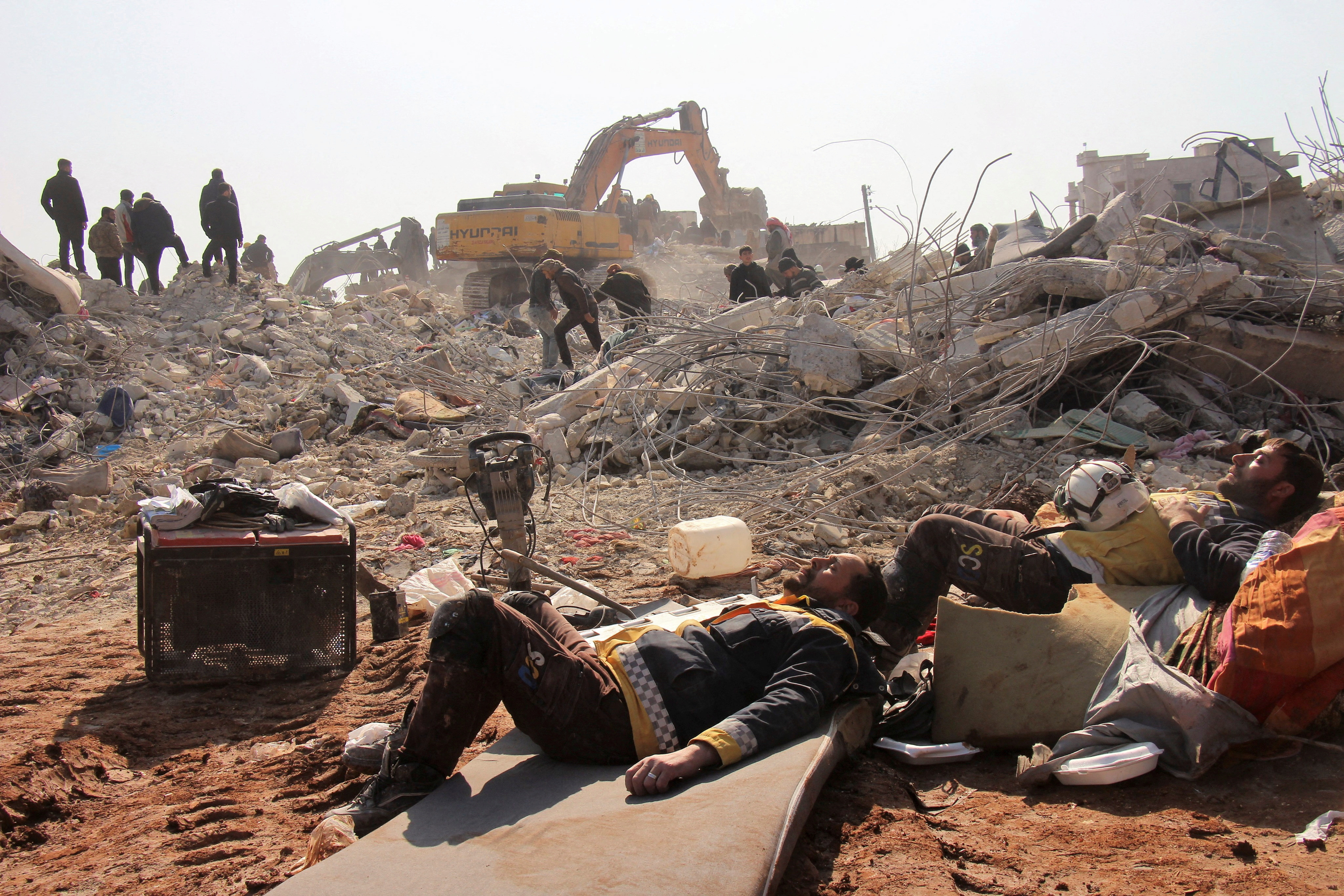 White Helmets members rest on day five of the rescue operations after a massive earthquake in Jandaris, Syria February 10, 2023 in this image obtained from social media.