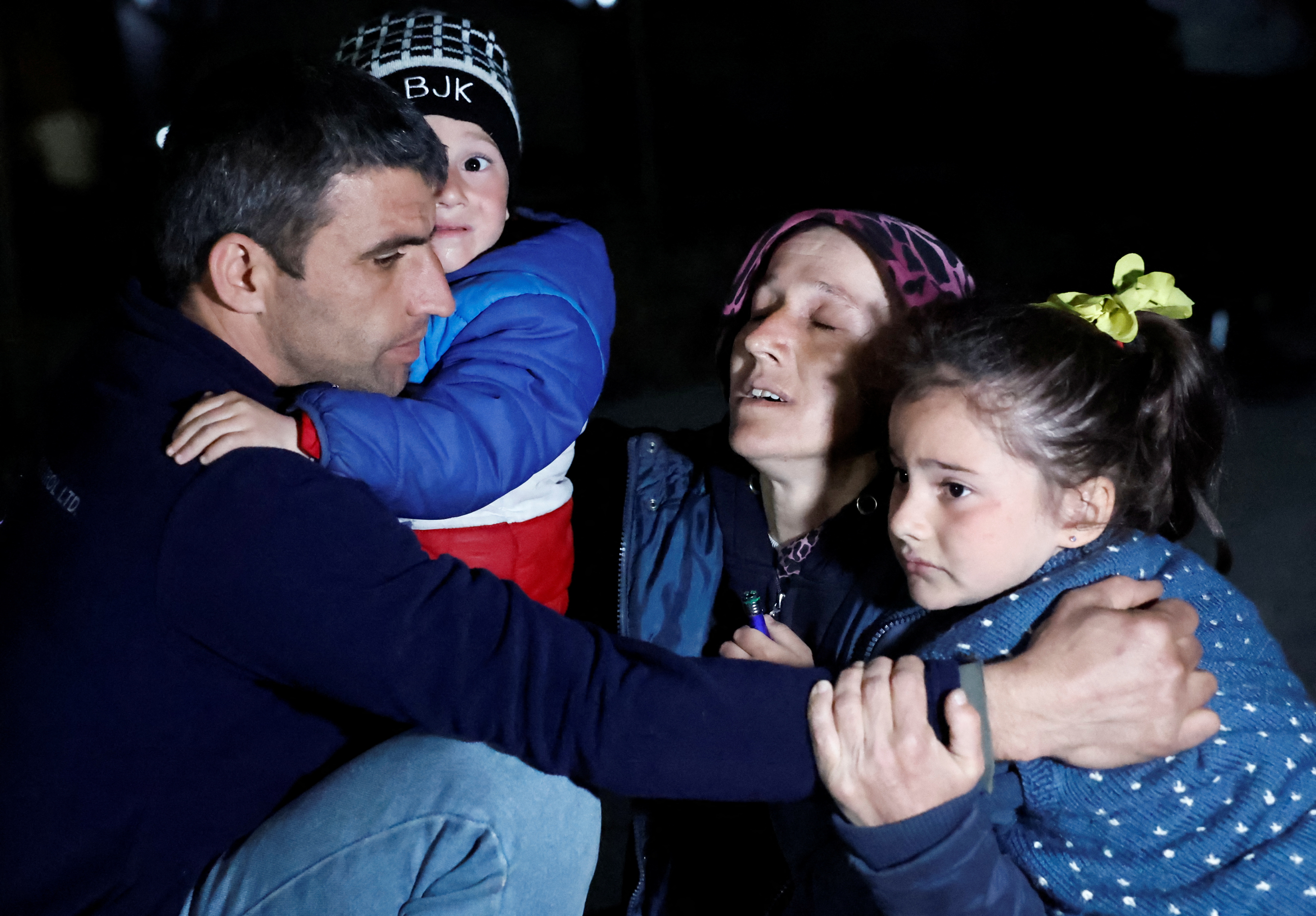 People react after an earthquake in Antakya