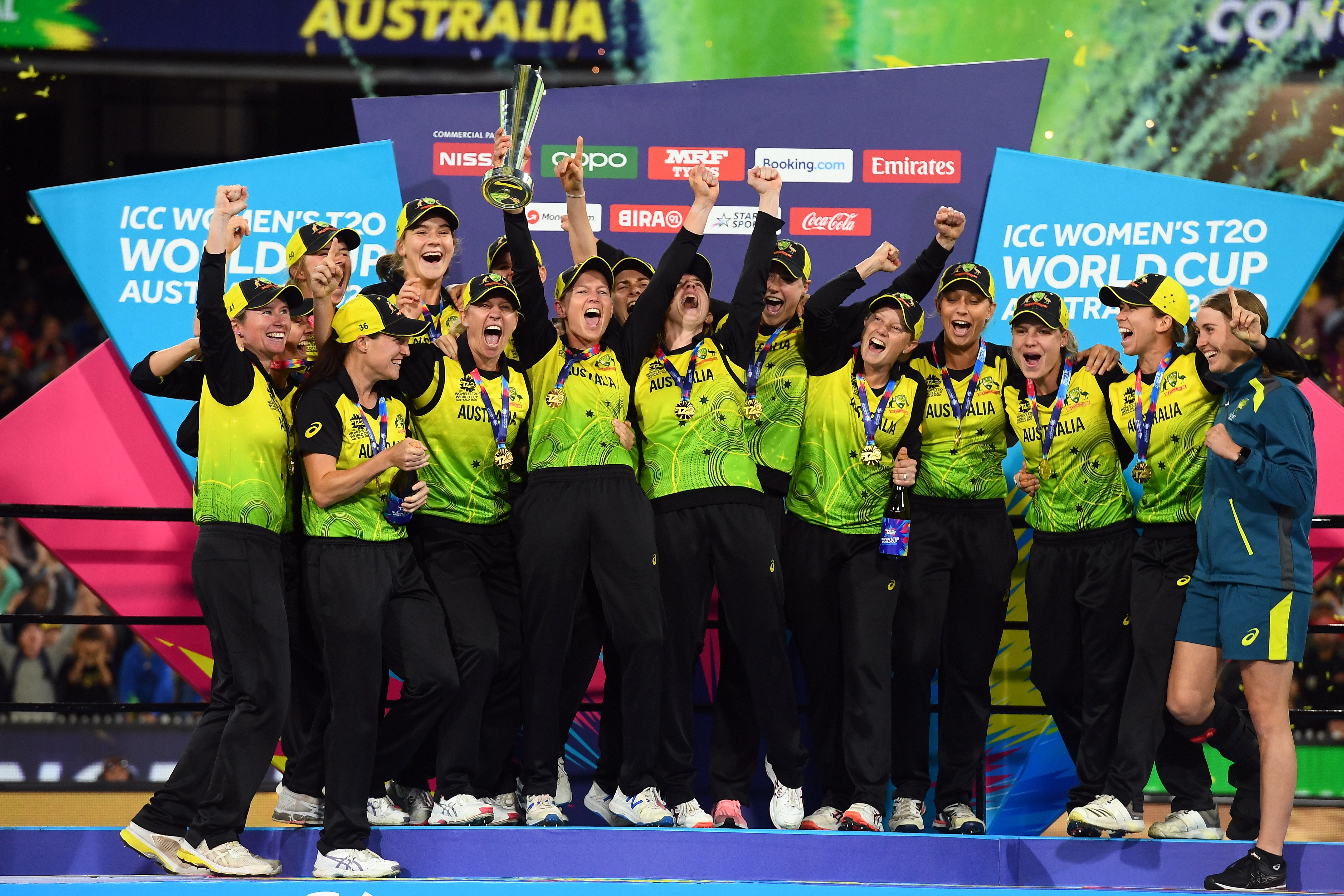 In this file photo taken on March 8, 2020, Australia players celebrate with the winning trophy of T20 women’s cricket World Cup