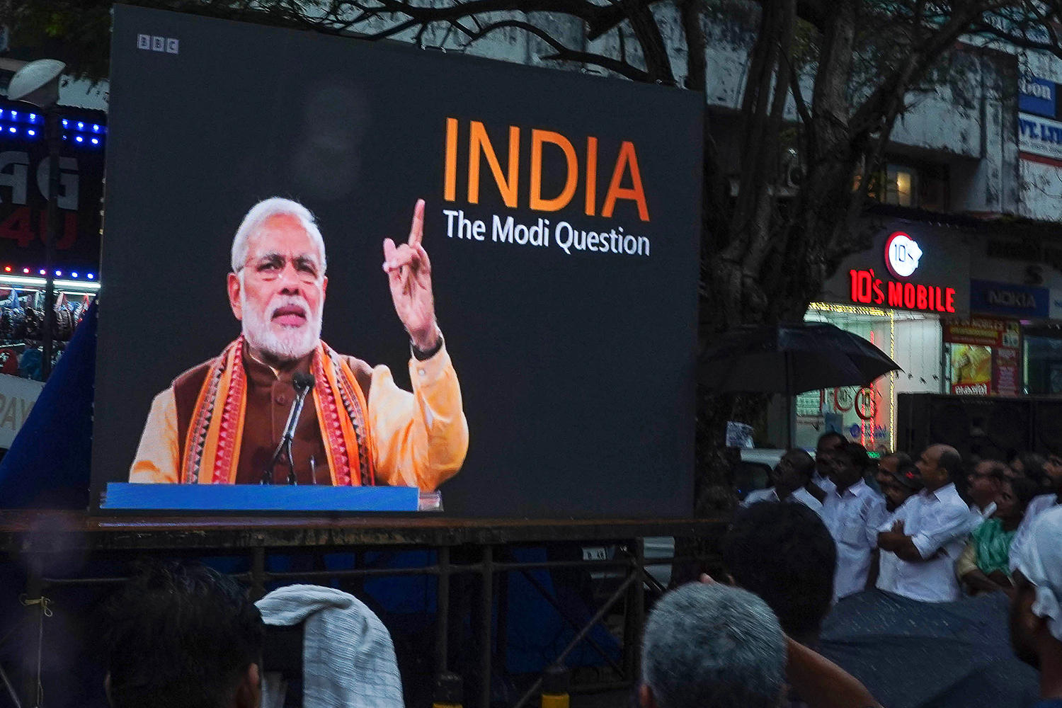 People watch the BBC documentary India: The Modi Question, on a screen installed at Marine Drive in Kochi