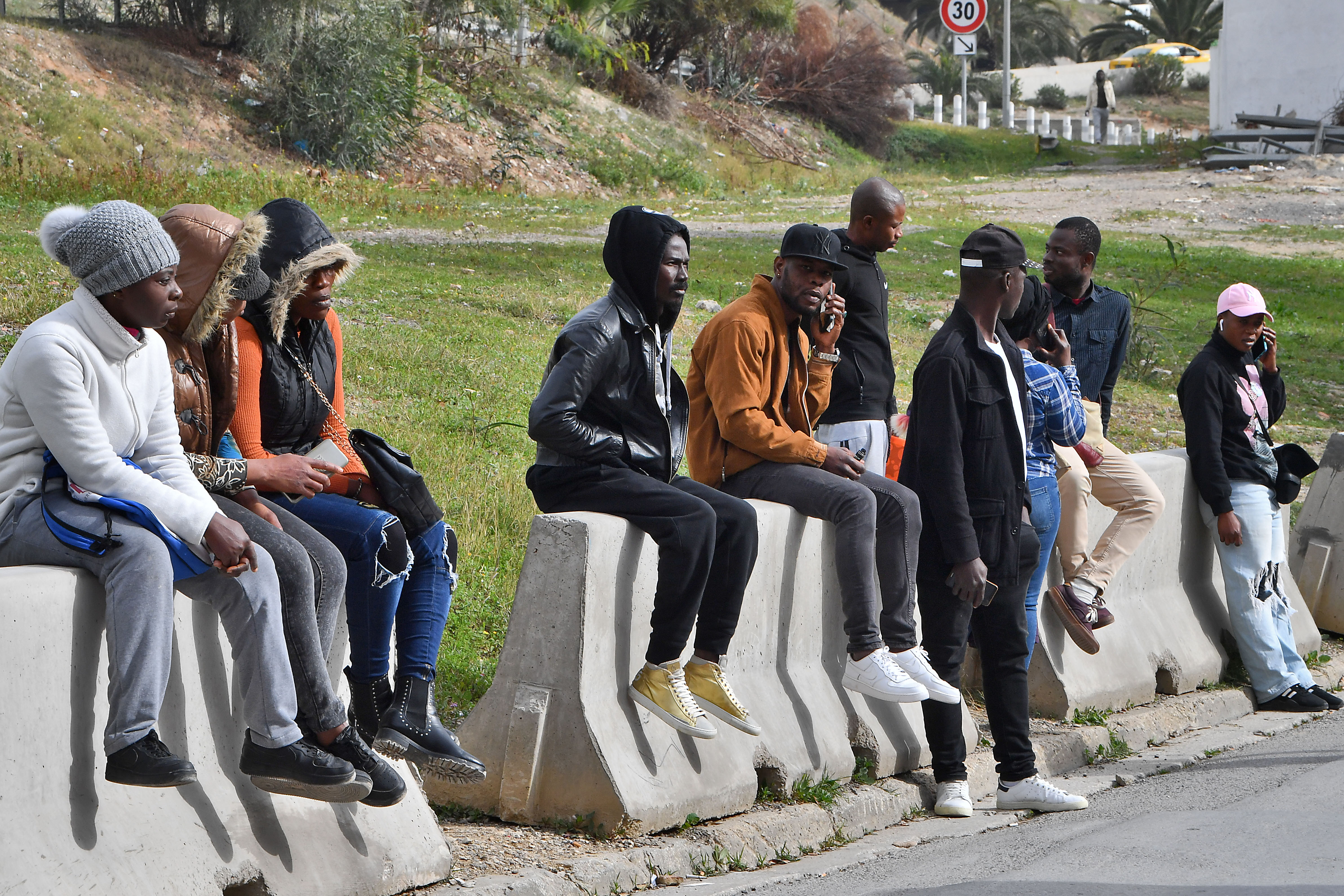 Ivorians wait outside the Ivory Coast’s embassy in Tunis for their repatriation to Abidjan on February 24, 2023