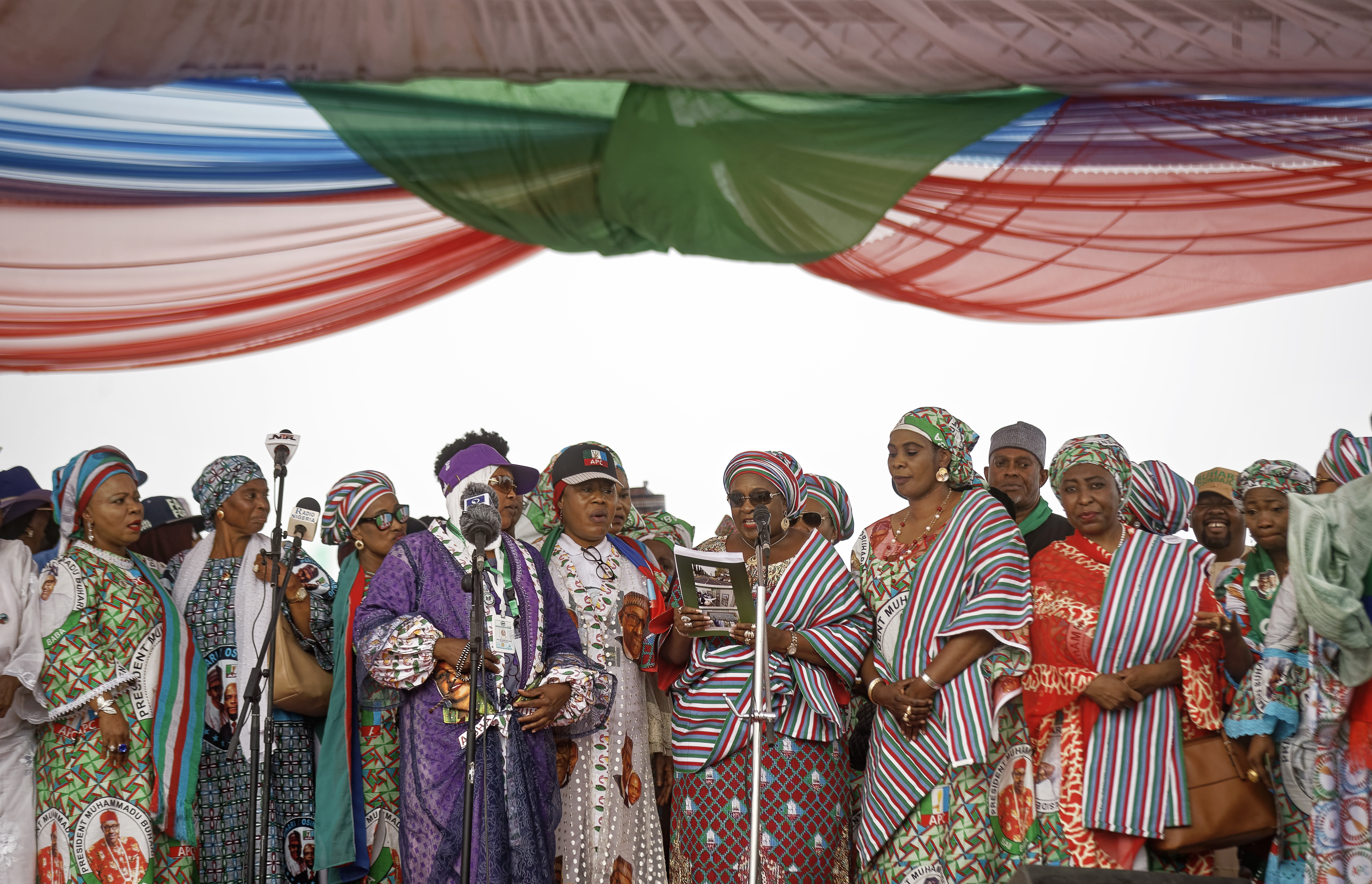 Women party members and officials take the stage to speak at a rally of the ruling All Progressives Congress