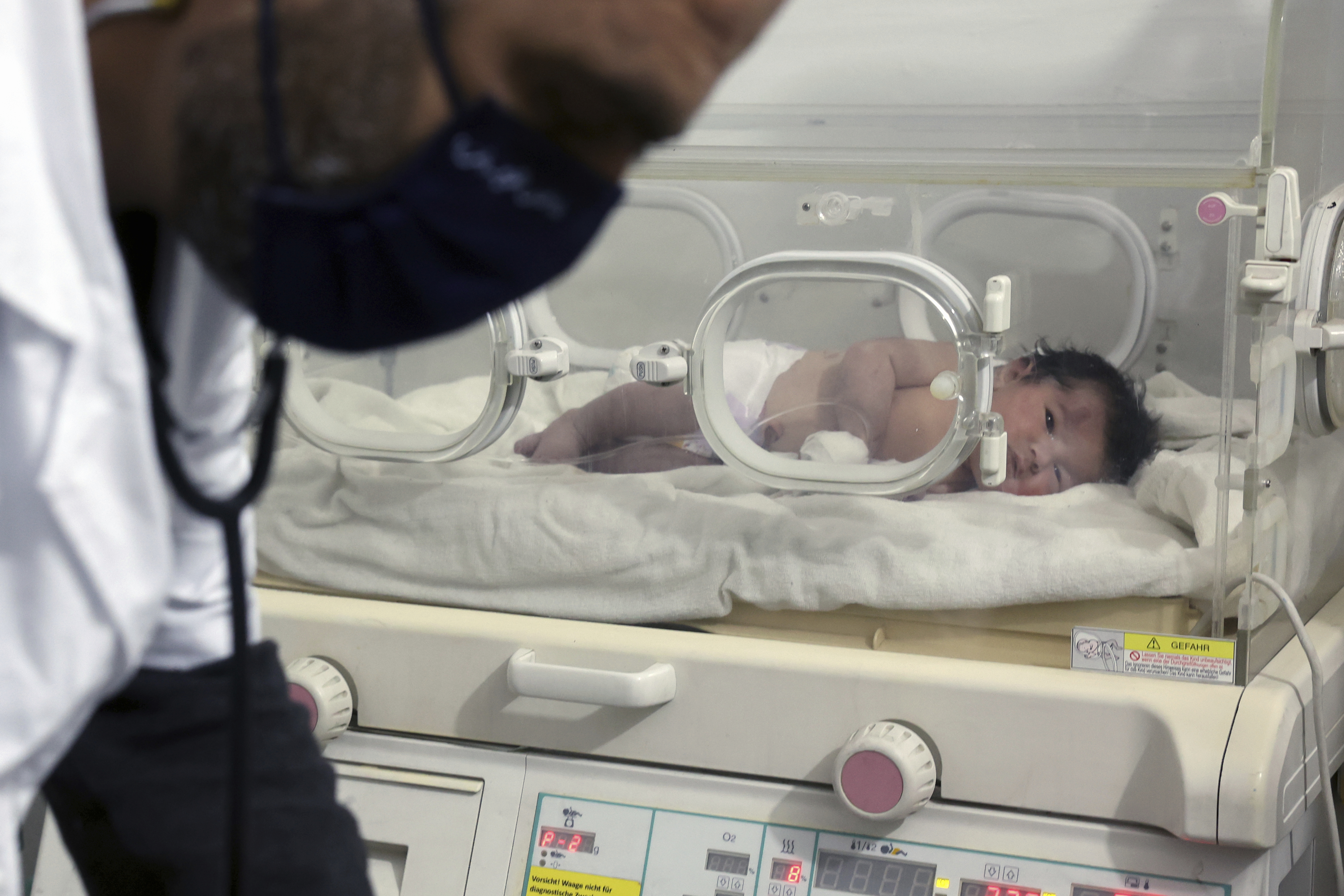A baby girl who was born under the rubble caused by an earthquake that hit Syria and Turkey receives treatment inside an incubator at a children's hospital in the town of Afrin, Aleppo province