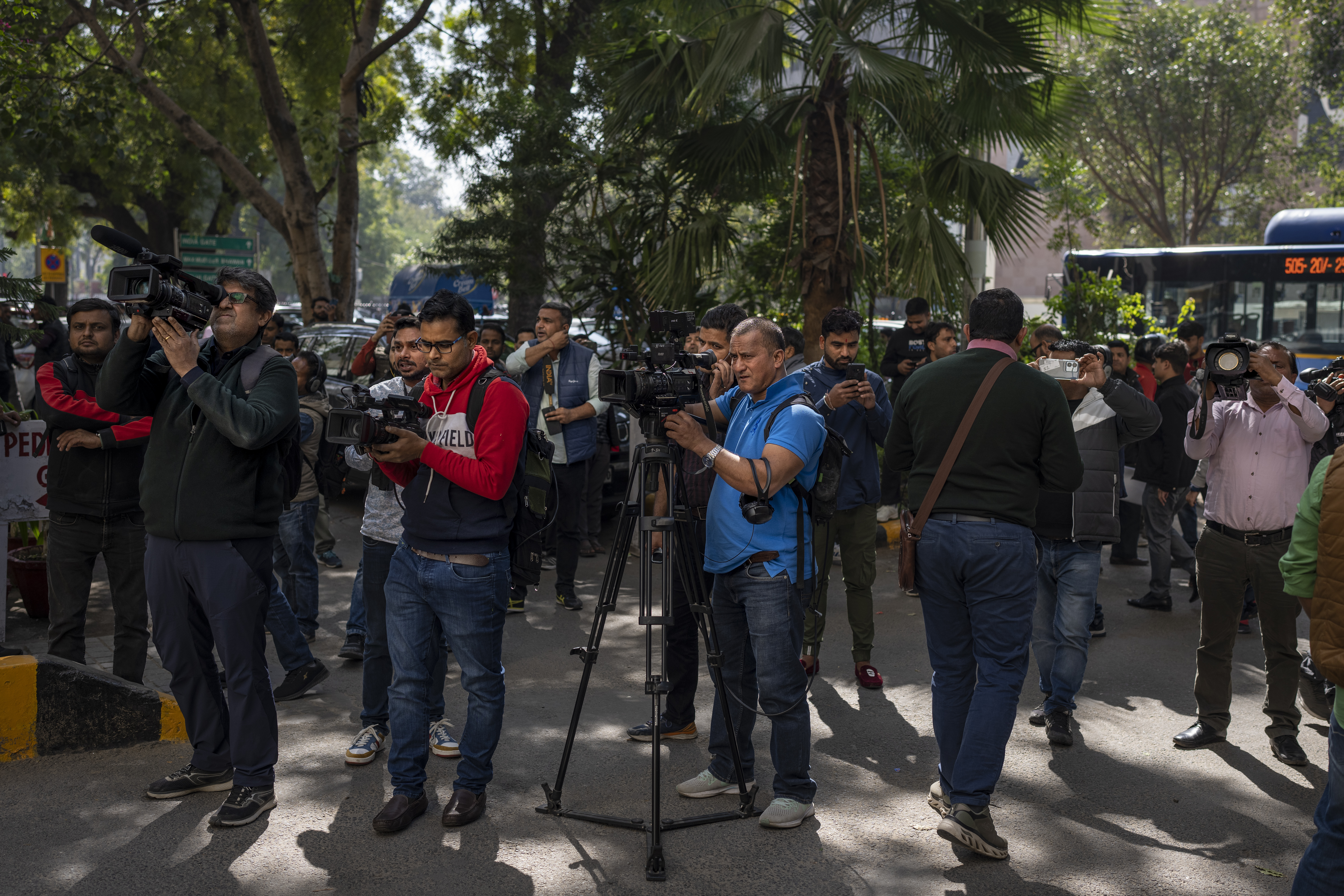 Media stand outside a building housing the BBC office in New Delhi, India