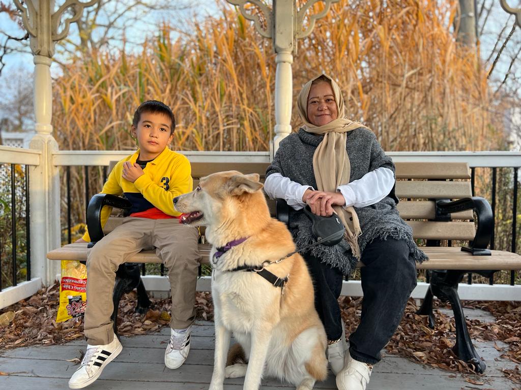 Ali and his mother, Aqila, with Ash, their sponsor Brennan’s dog, in Toronto in November 2022 [Courtesy of Brennan Leffler]
