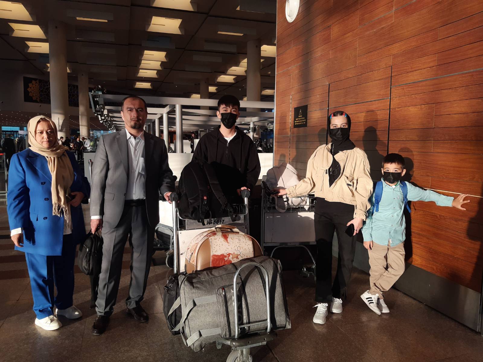 Aqila, left, with her husband and children, checking in for their flight to Toronto, at Islamabad Airport in October 2022 [Courtesy of Mahnaz Aliyar]
