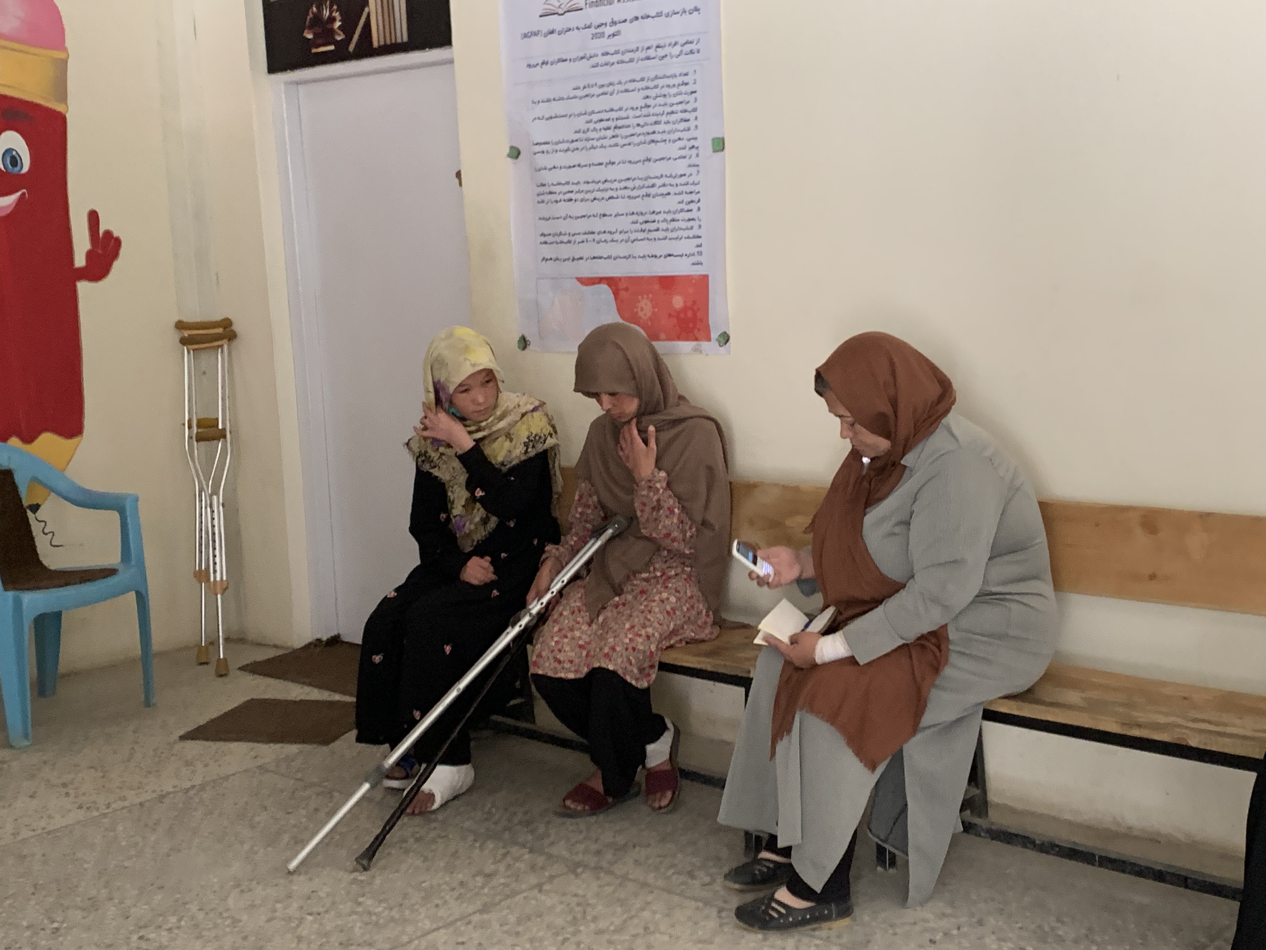 Aqila, in July 2021 when she was principal of Sayed ul-Shuhada girls’ school, sitting with students injured in the May 2021 bomb attack that killed 85 people in Kabul